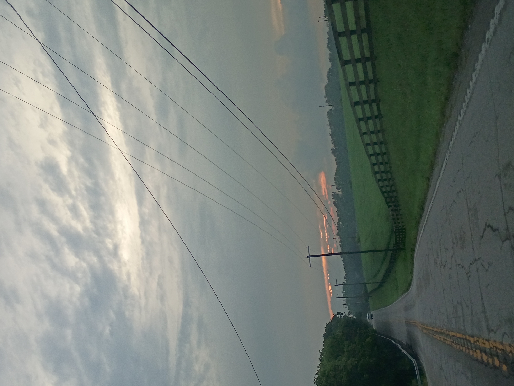 Quiet rural road outside Lexington under a pale orange sky