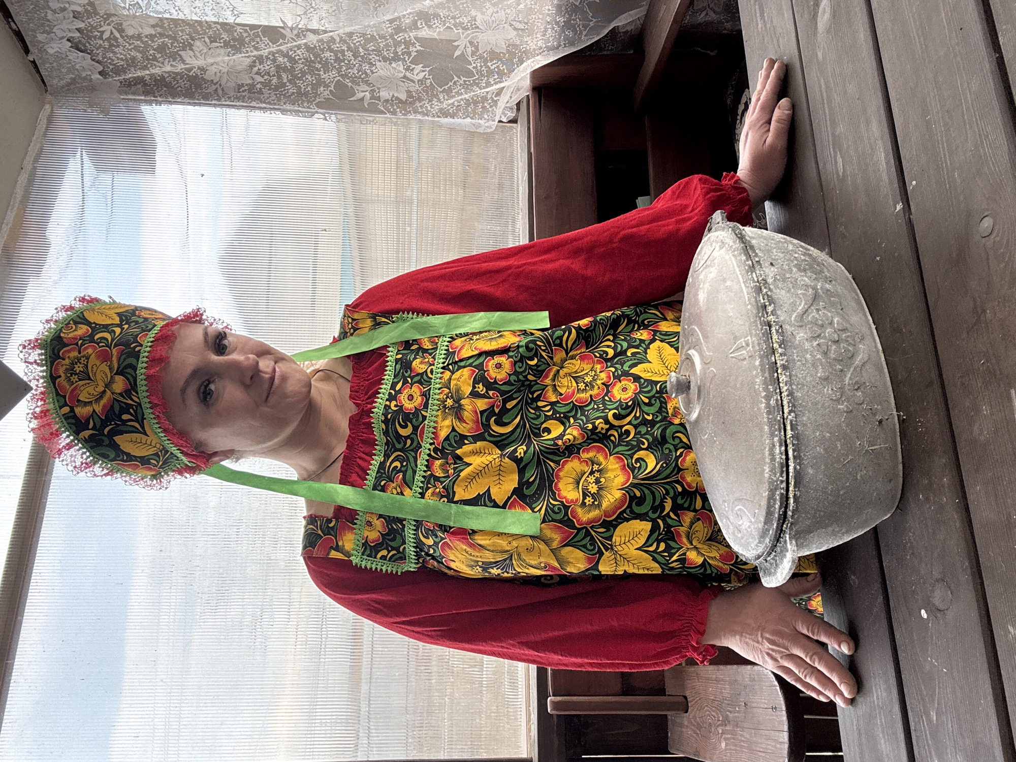 Woman in traditional Russian dress tends garden in Chaikovsky