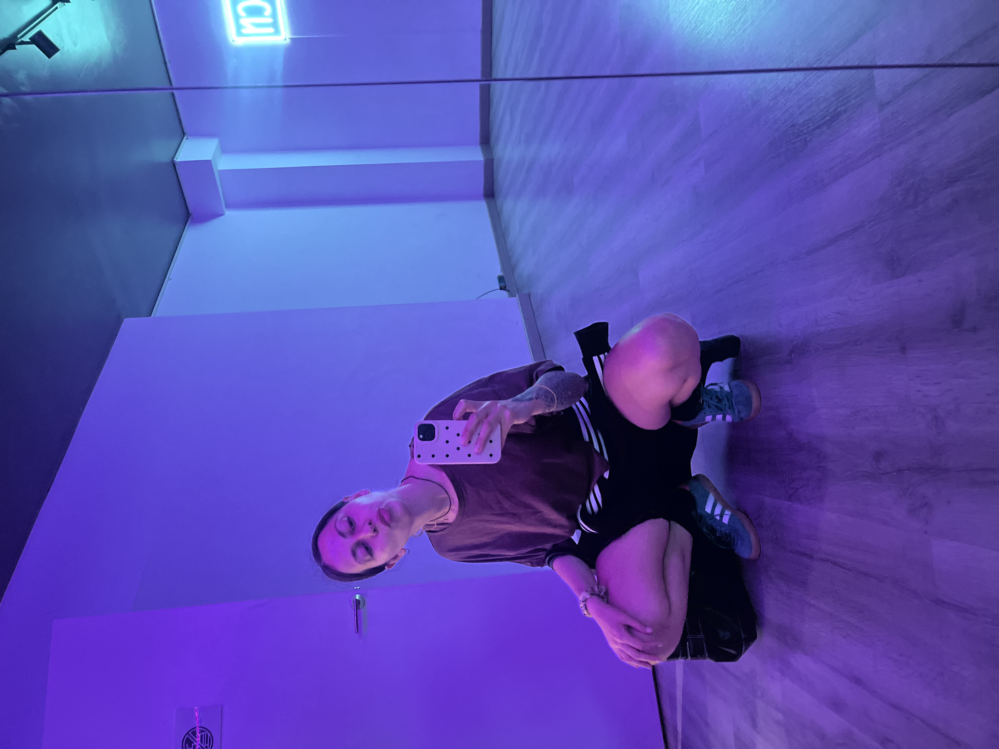Barcelona studio selfie captured under colorful neon lighting