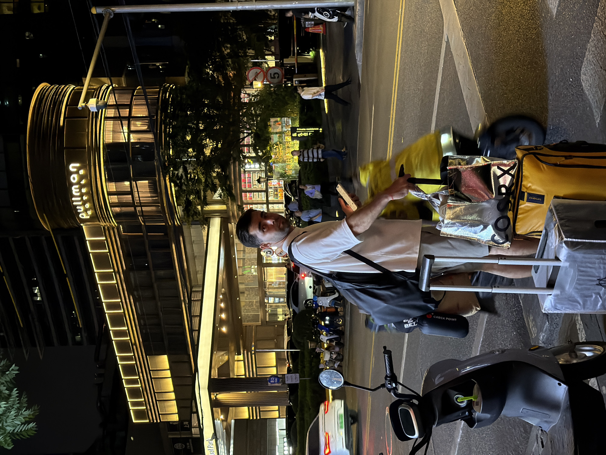 Nighttime street scene captured near Pullman Hotel in Shanghai