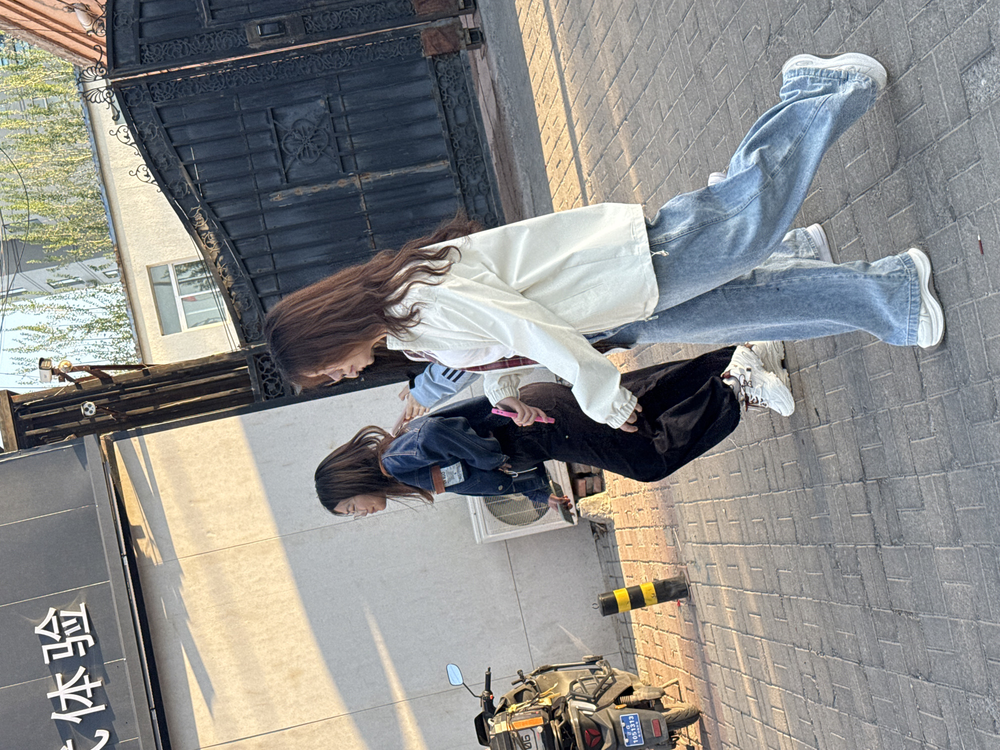 Young women photographed on sunny Zhongtun streets