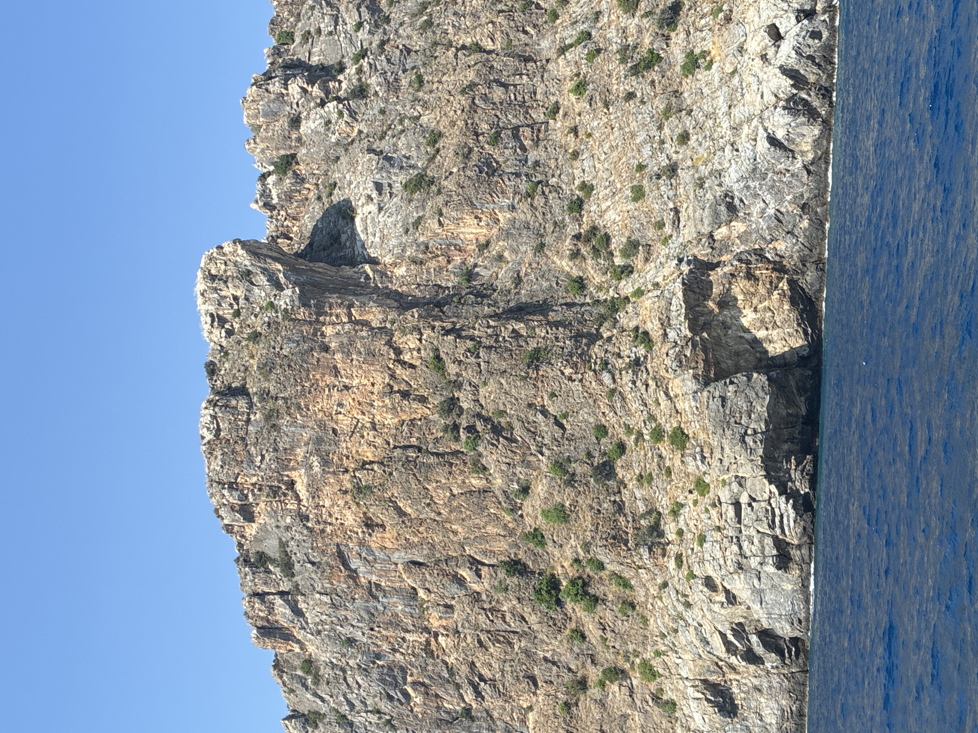 Rugged coastal cliffs meet clear blue sea in southern Turkey