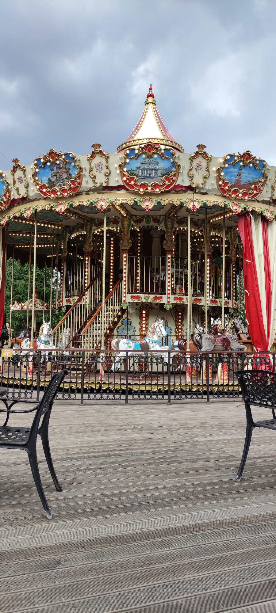 Ornate carousel and garden seating at a Moscow outdoor venue