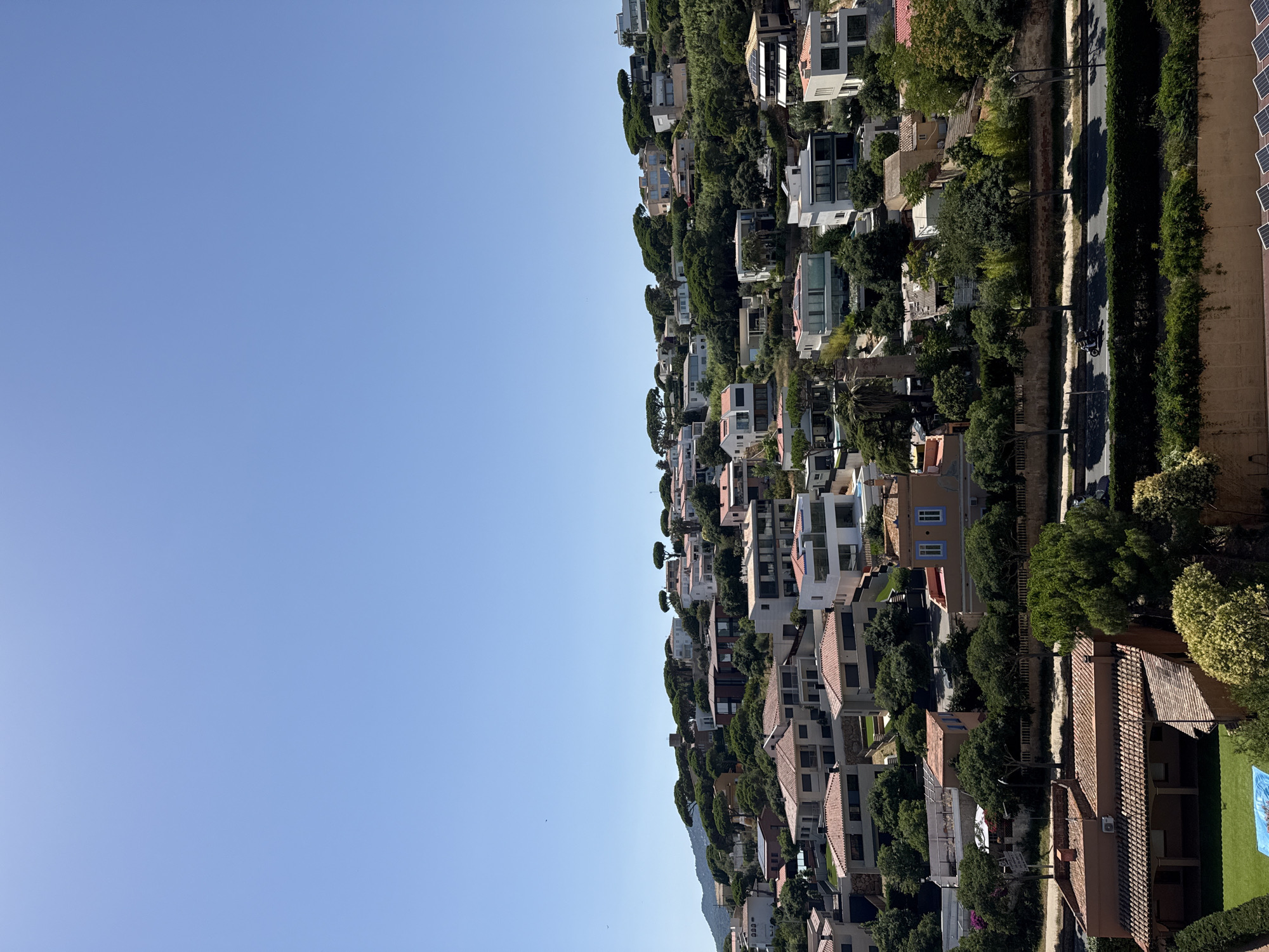 Sunny hillside neighborhood overlooking the Costa Brava coast
