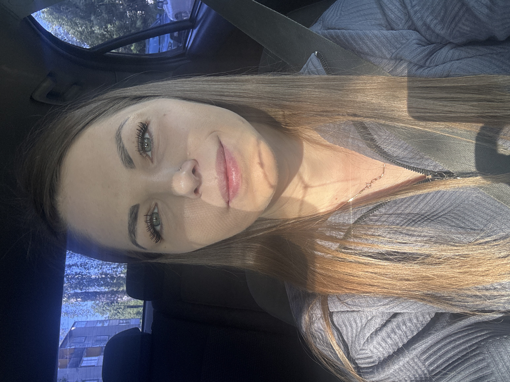 Woman photographed seated in car in Razdolye, Russia