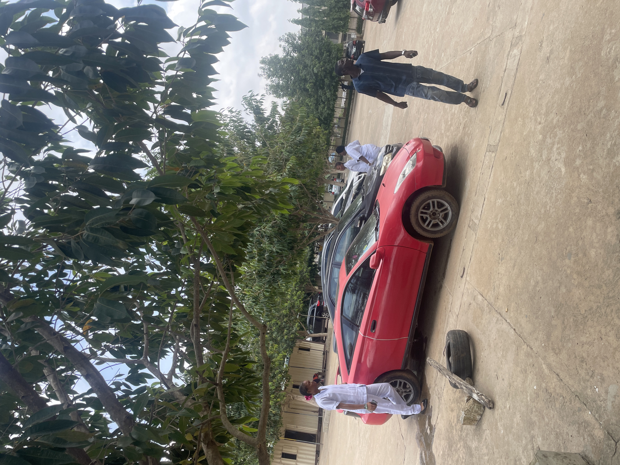 Vehicles parked in an open compound, Abuja