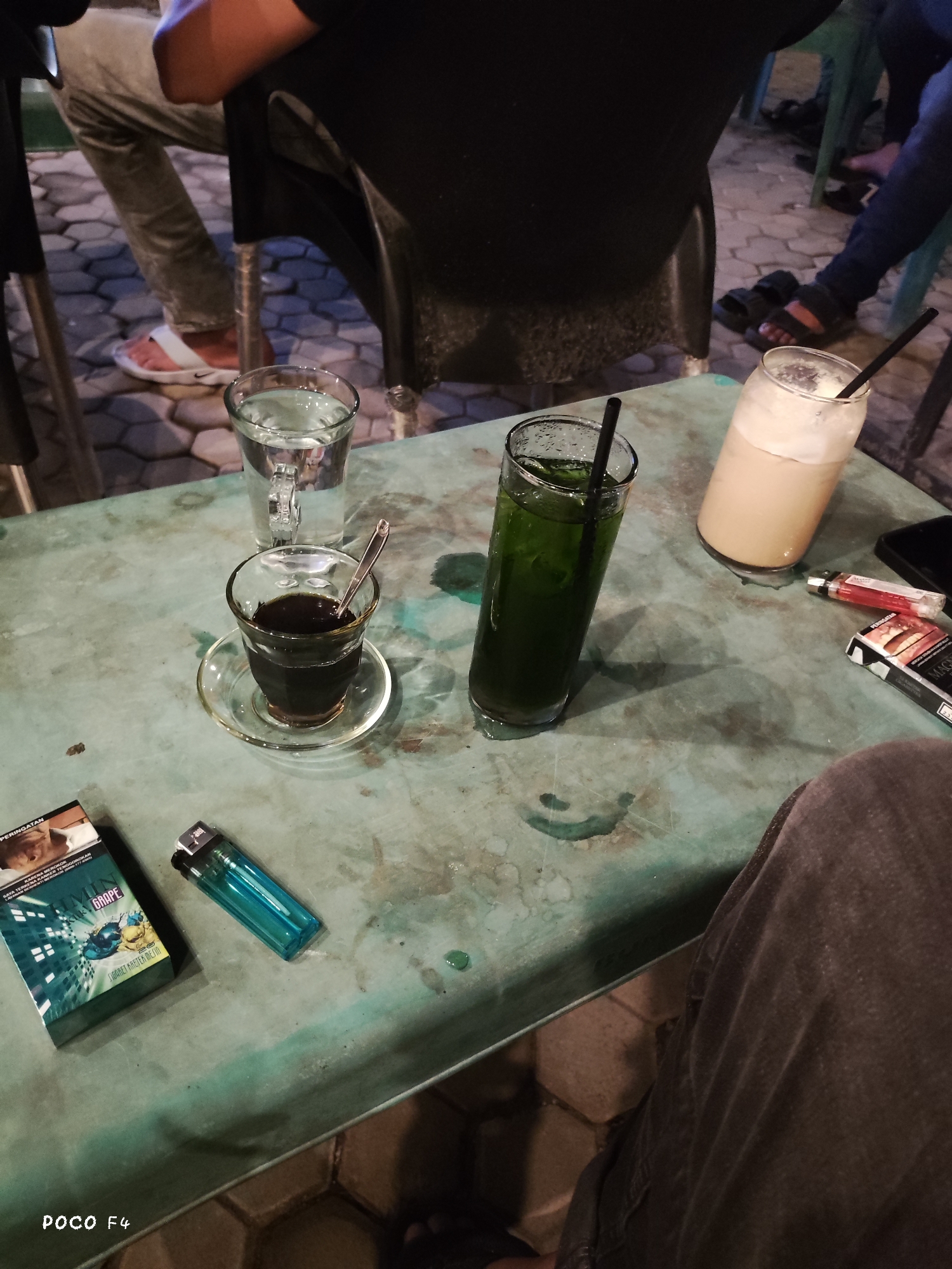 Nighttime café crowd gathers to watch live sport outdoors