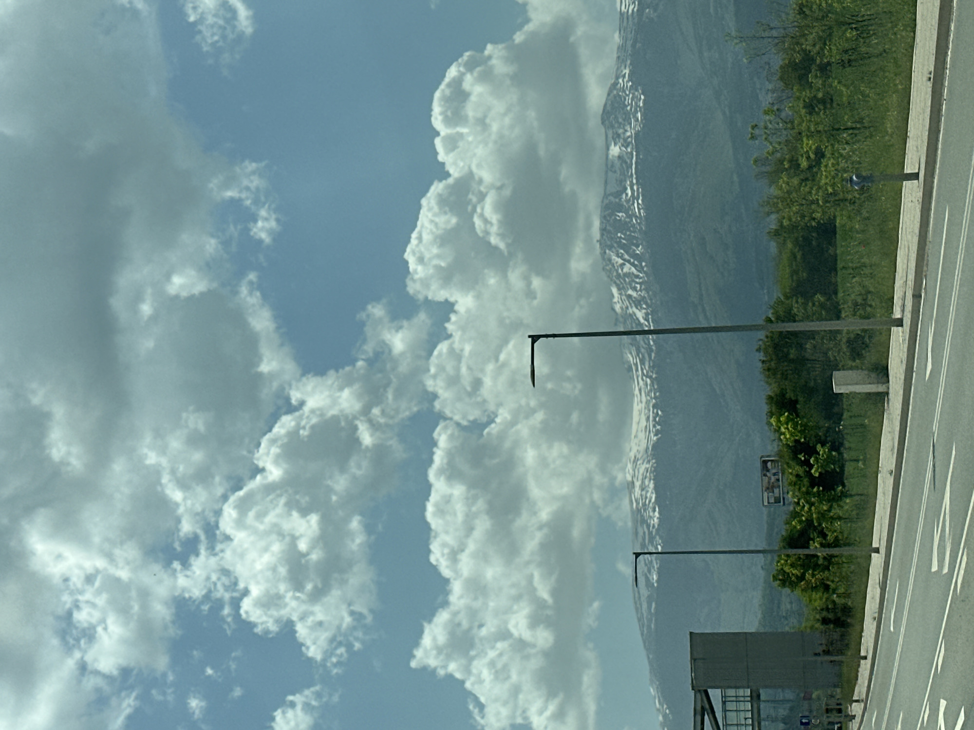 Snow-capped mountains visible from roadside in Lozen, Bulgaria