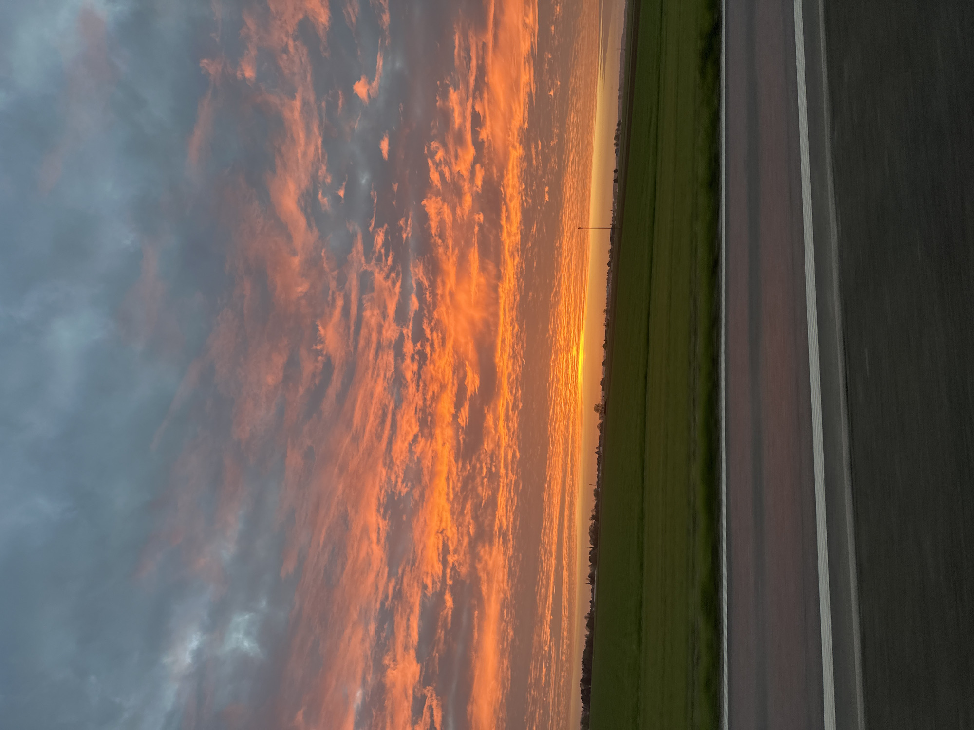 Vibrant sunset captured on road near Annœullin, France