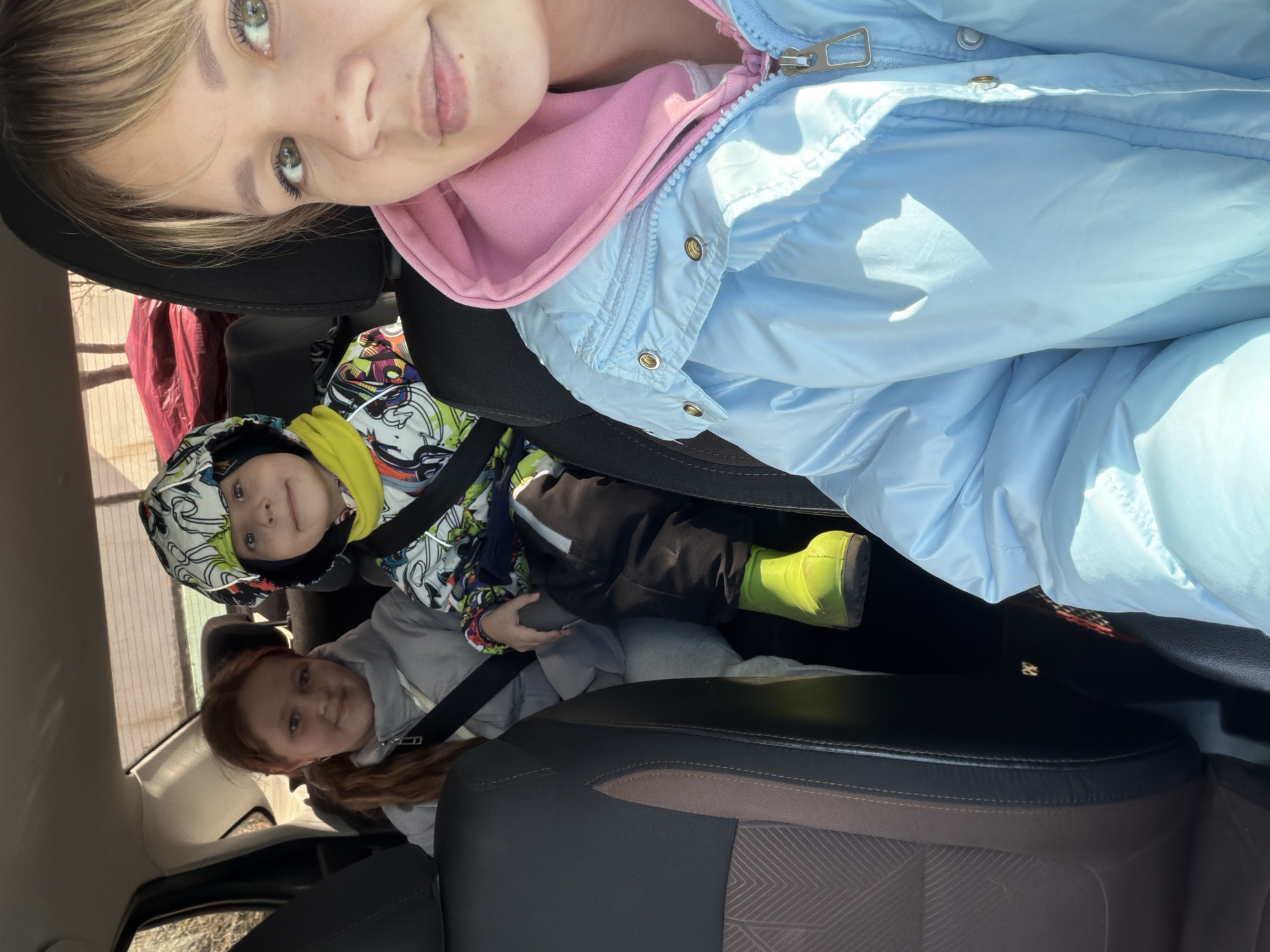 Family car trip with children includes stop for dog interaction