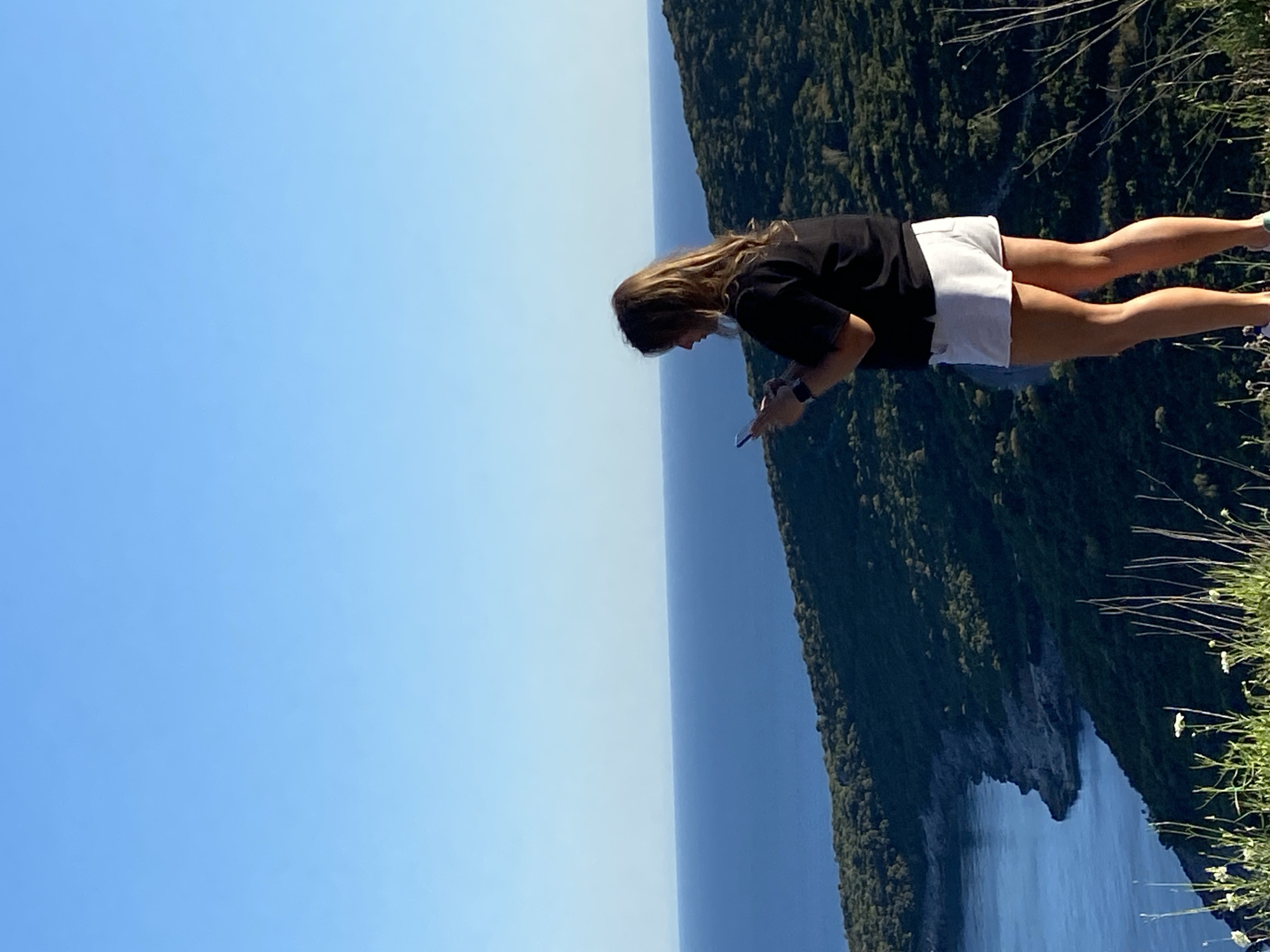 Woman photographs Adriatic coastline from Montenegro cliffs