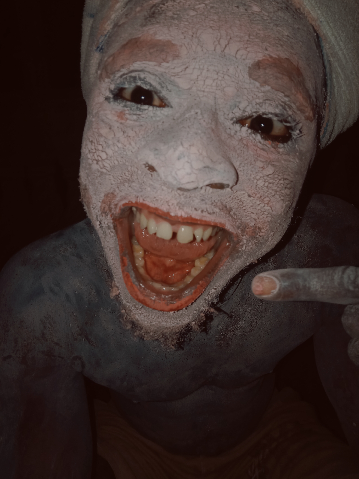Person in traditional white clay paint photographed in Onitsha