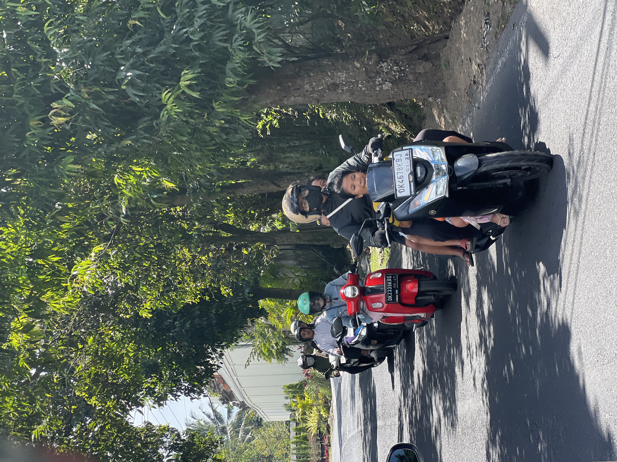 Traffic and temples mix on a busy Ubud street