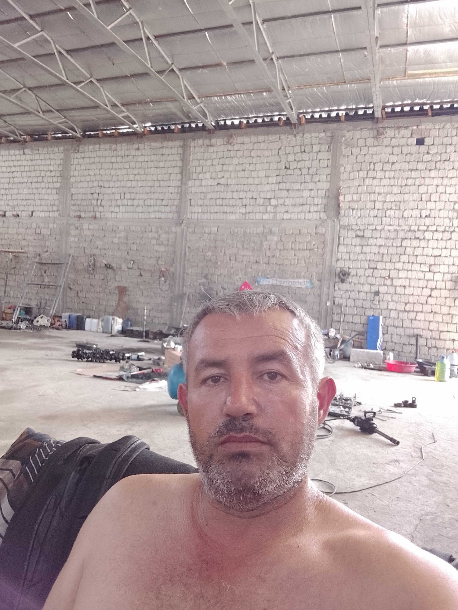 Man Takes Selfie in Uzbekistan Workshop