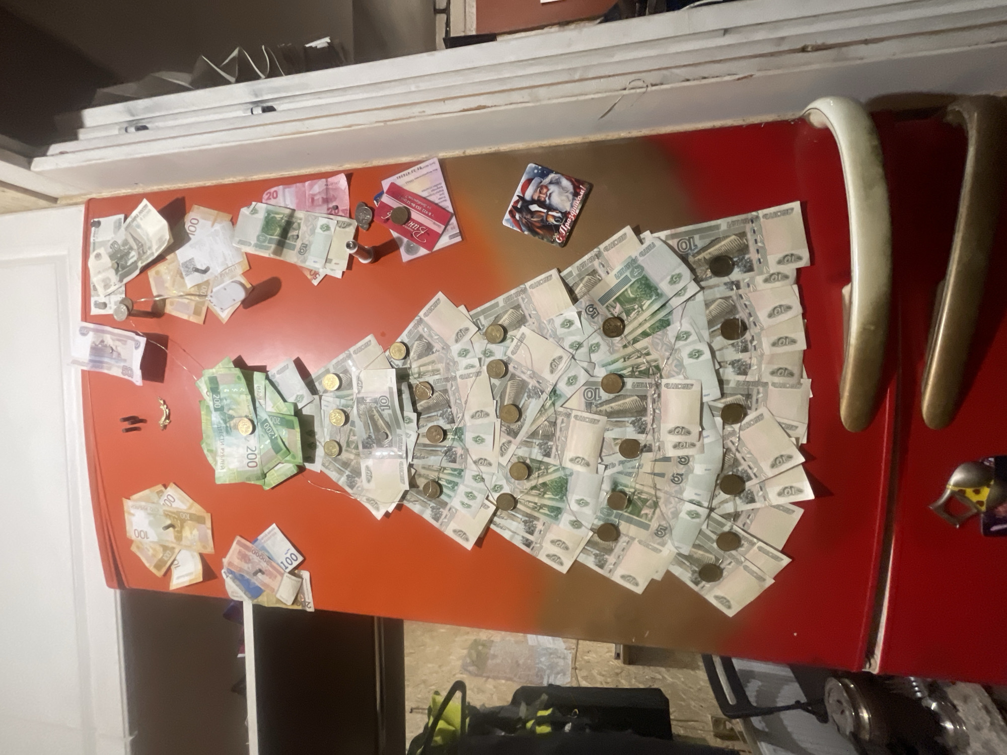 Russian refrigerator door decorated with ruble bills and coins