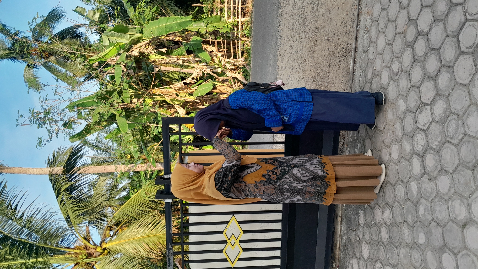 Traditional greeting ceremony between two women in Blangriek, Indonesia