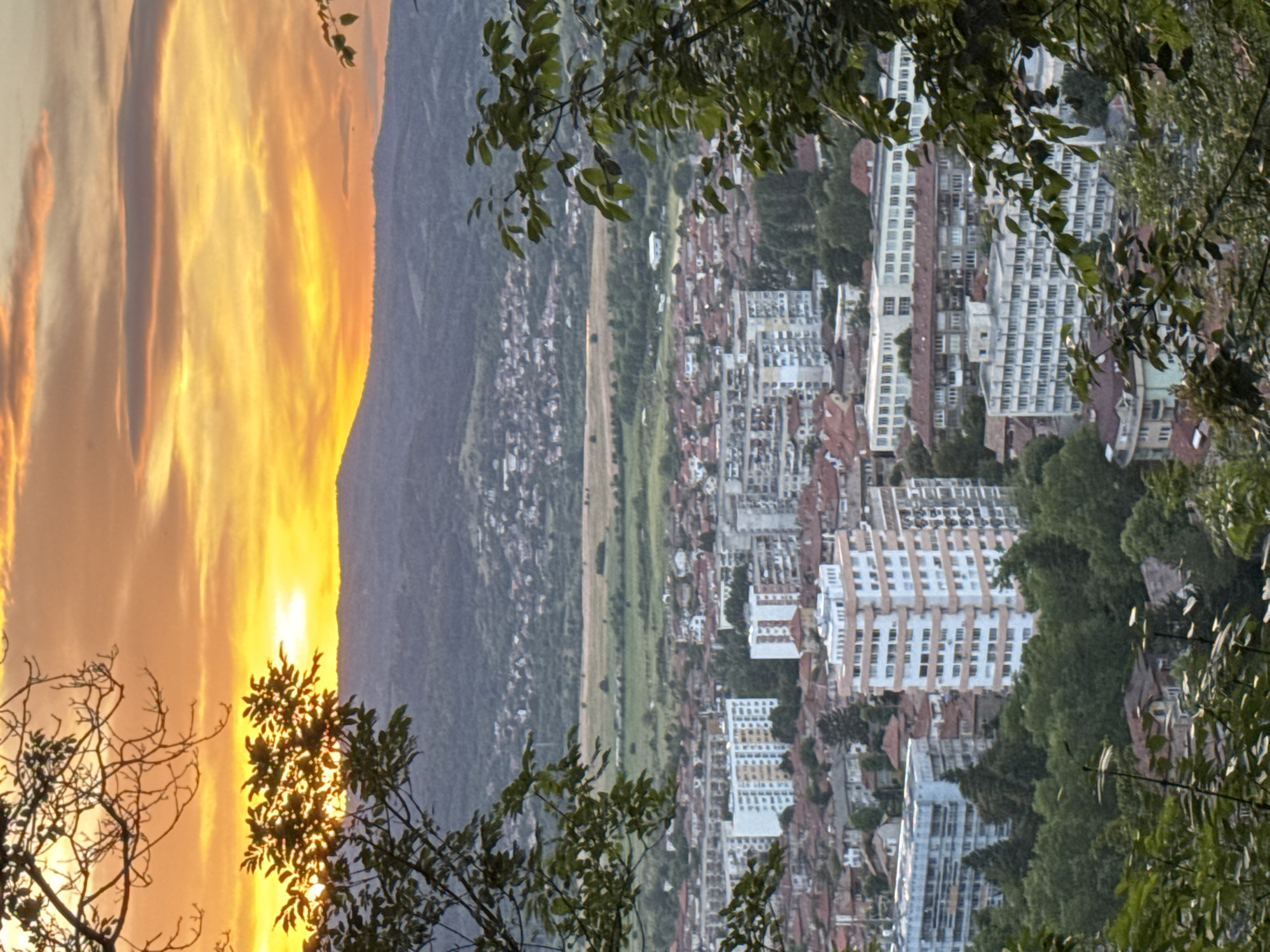 Sunset documented over mountain-divided city on May 30