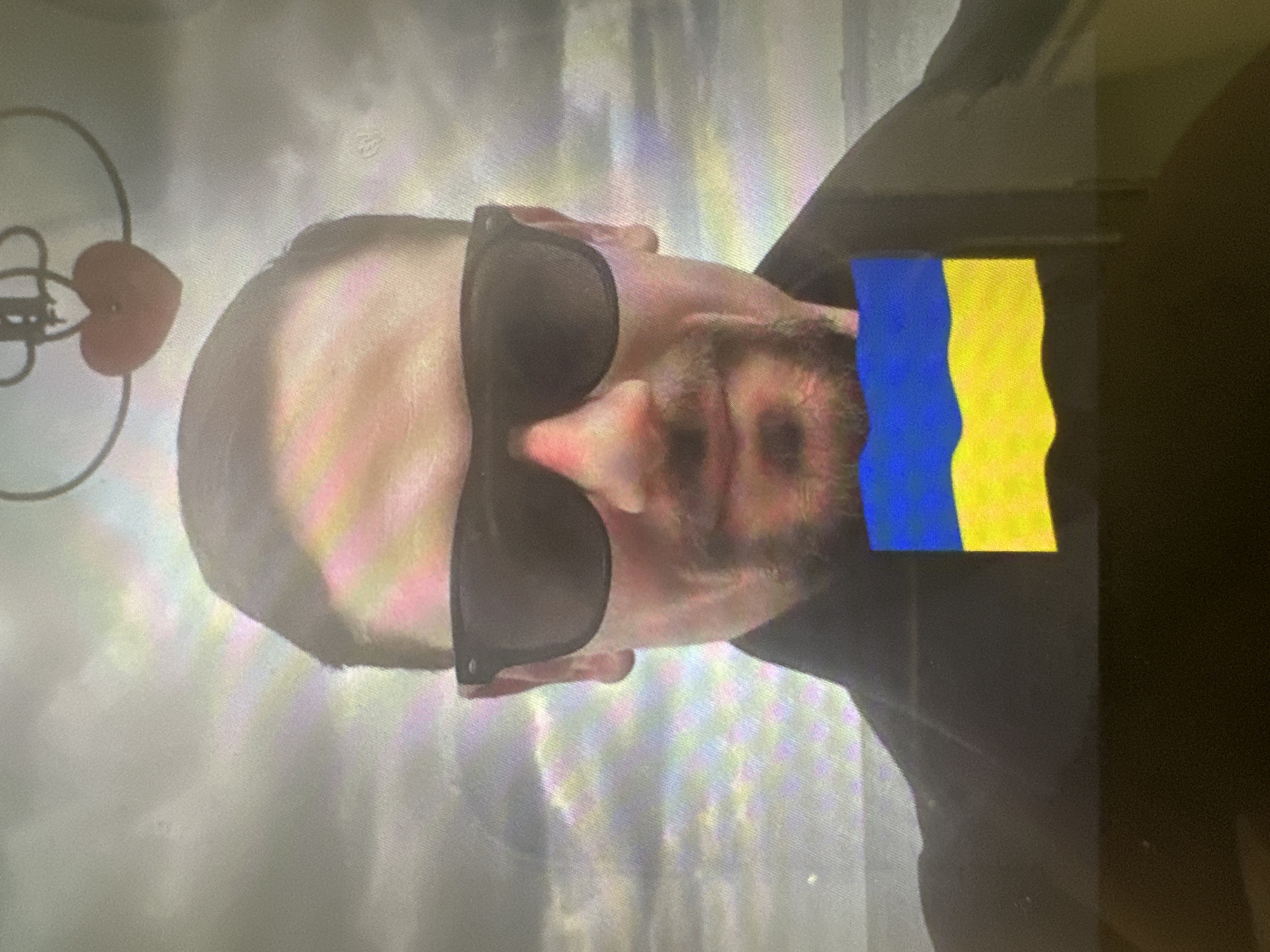 Stylized close-up portraits with sunglasses, one with Ukrainian flag