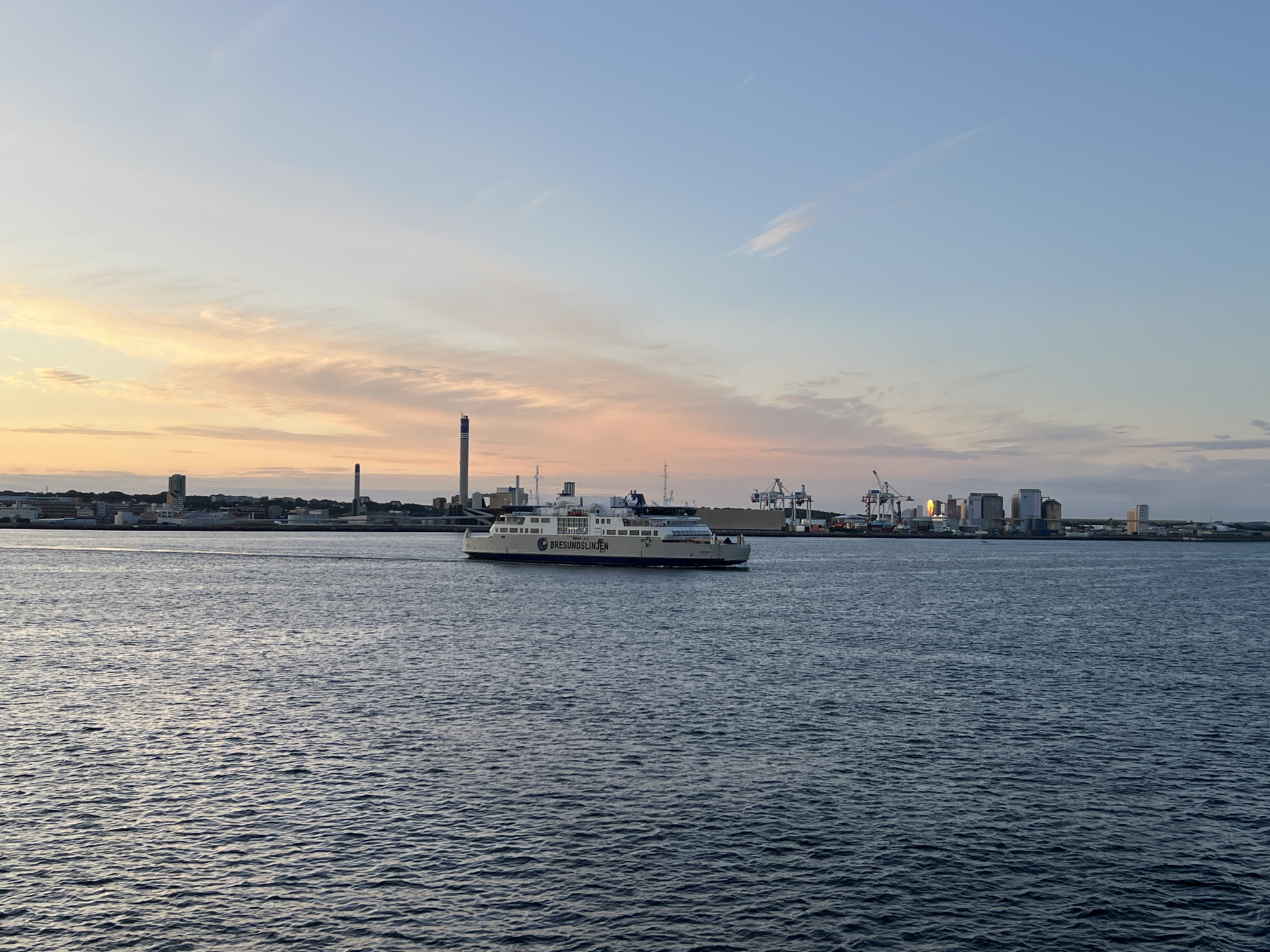 Öresundslinjen ferry crosses a calm Helsingborg strait at sunset