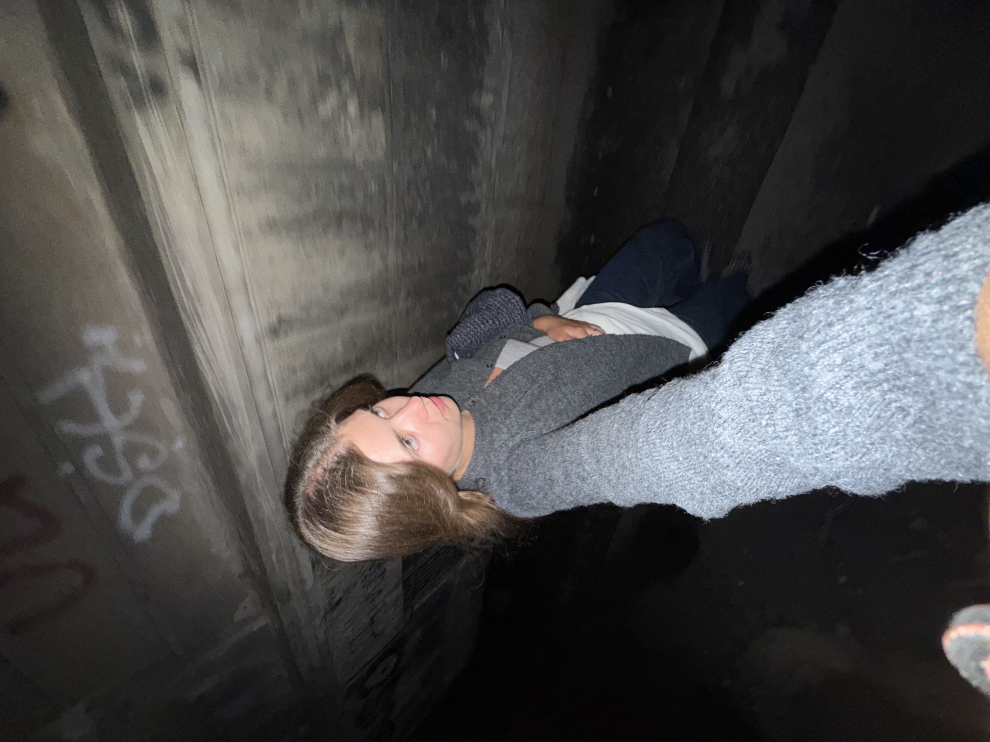Woman takes selfie in underground concrete structure in Belgrade