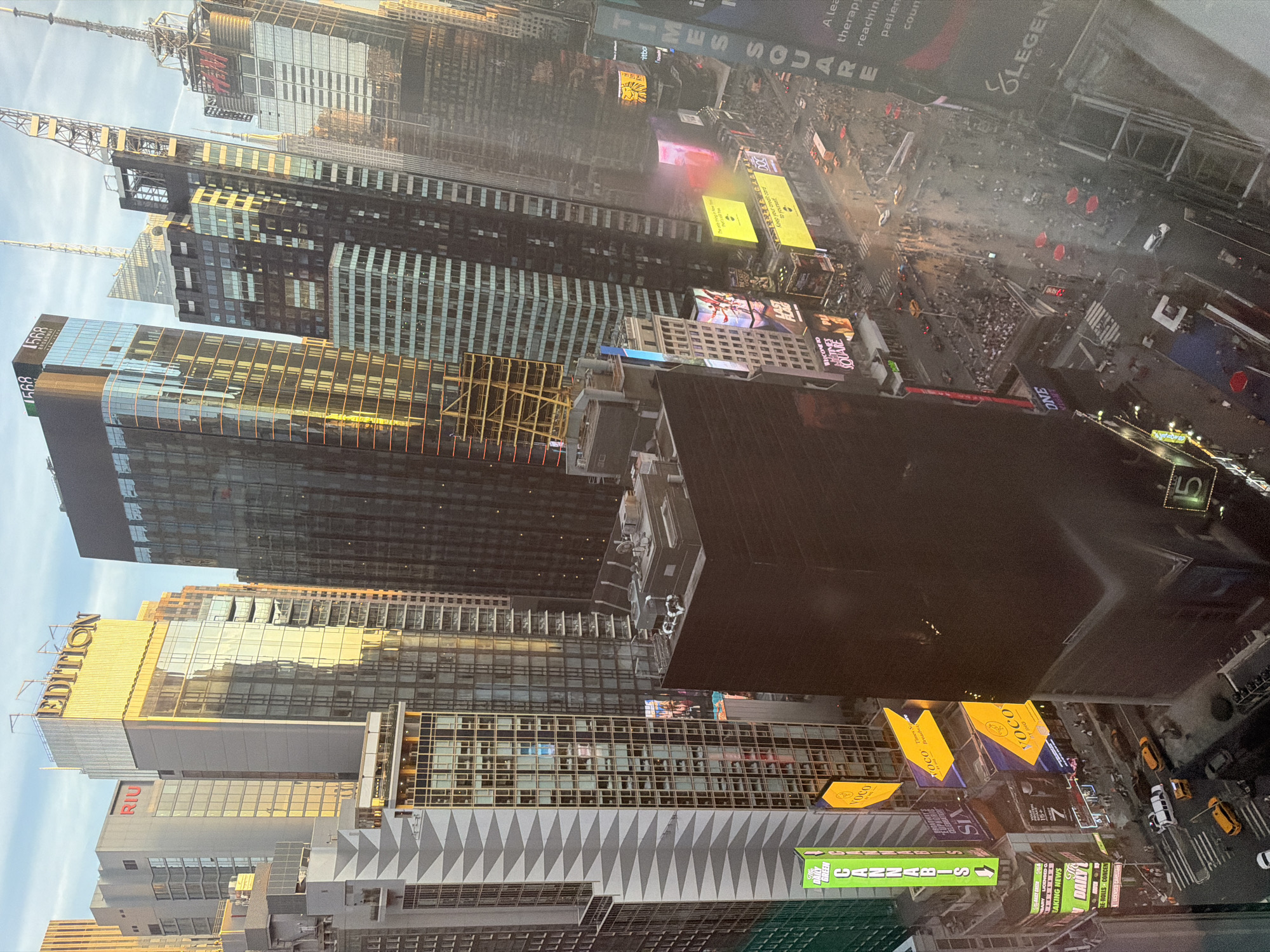 Aerial views document nighttime Manhattan cityscape from Times Square