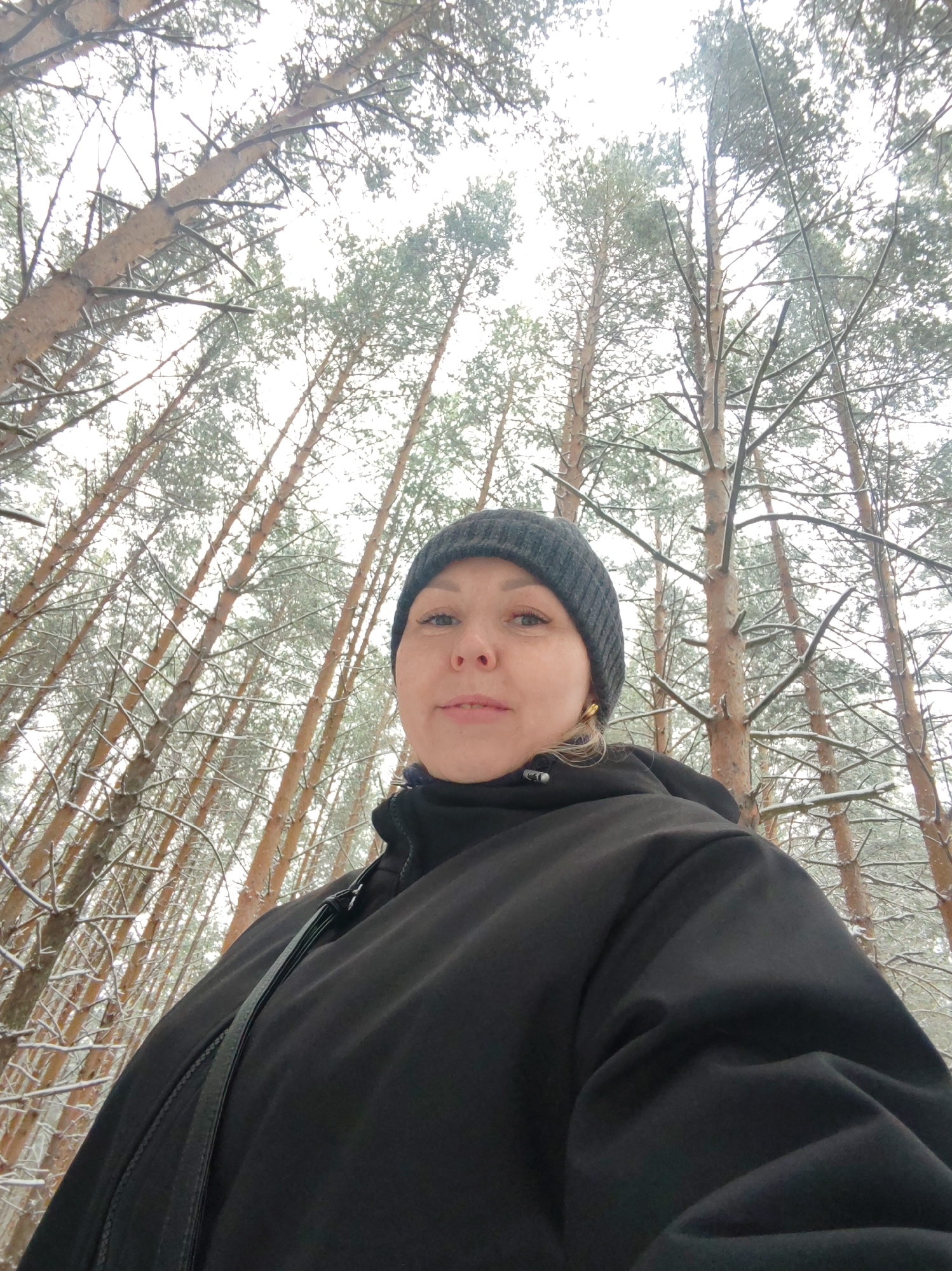 Woman and boy enjoy winter forest moment in Chaikovsky