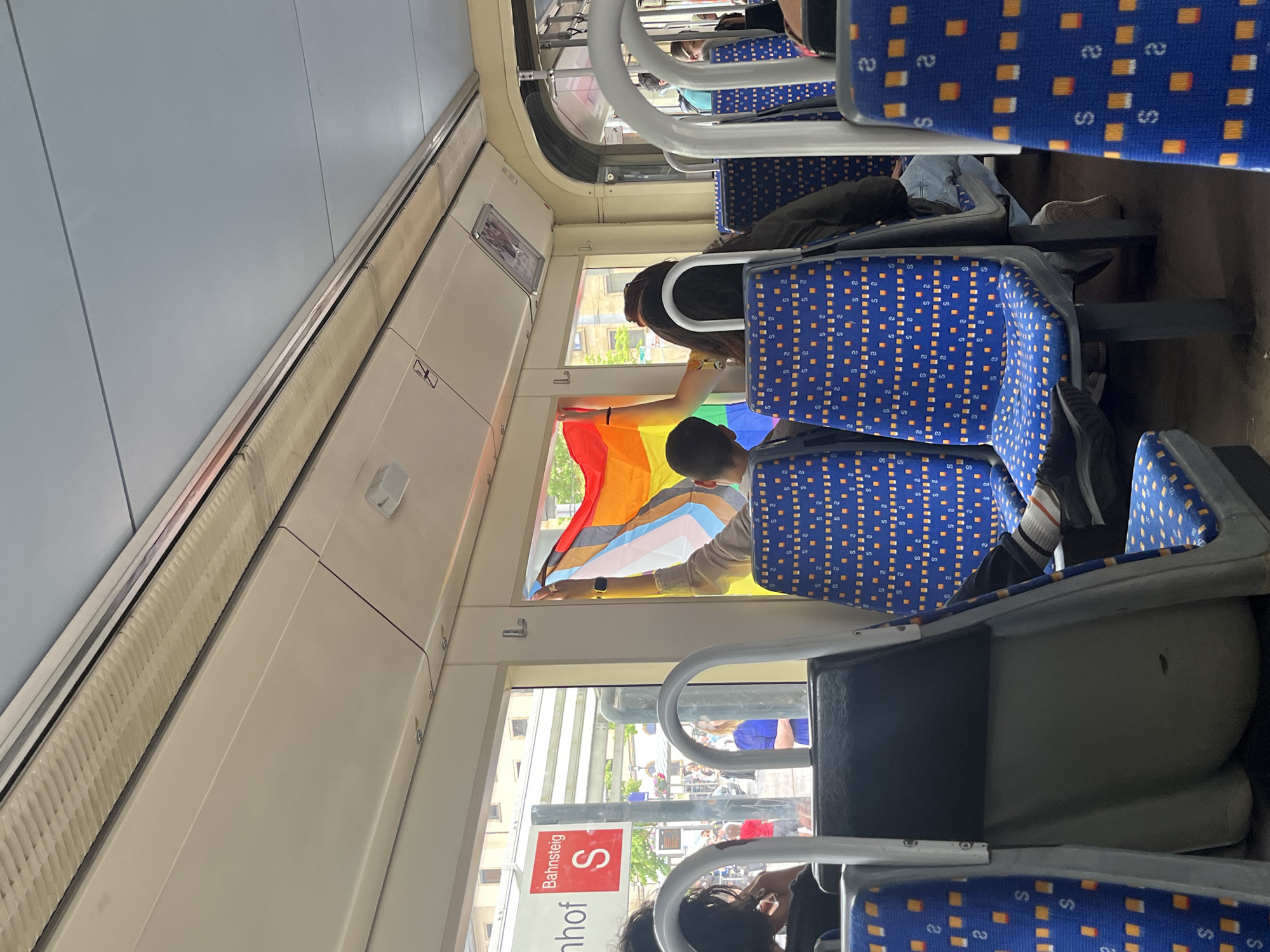 Pride flag displayed on Saarbrücken train, church street documented