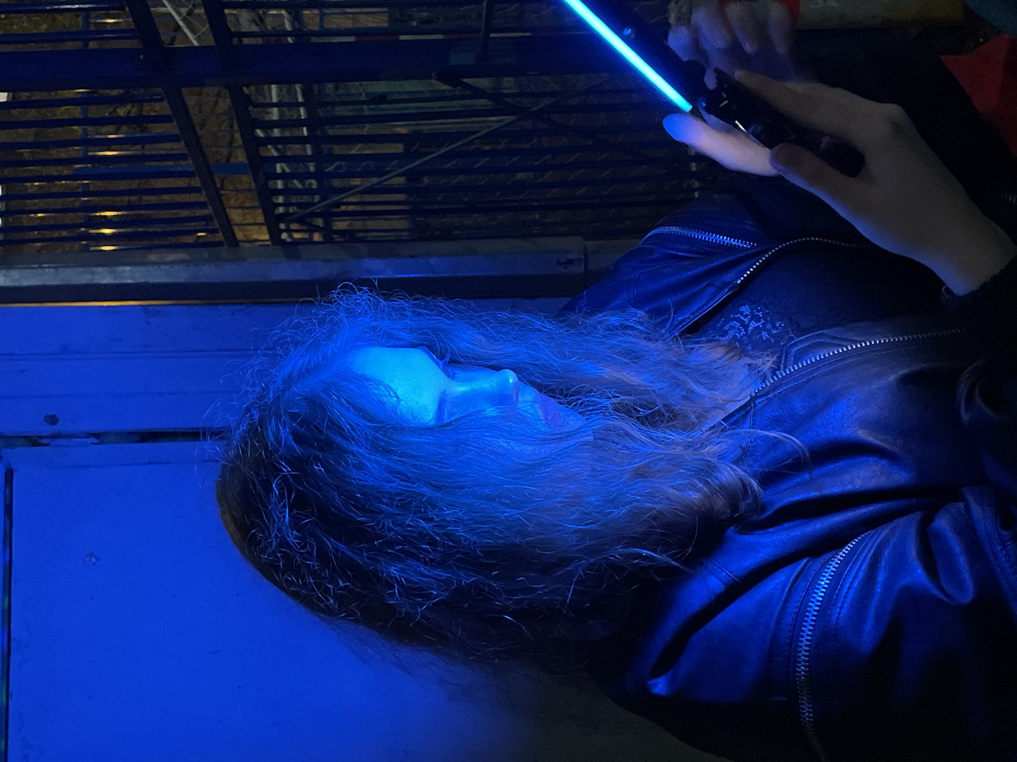 Person tests colored light device outside Moscow building