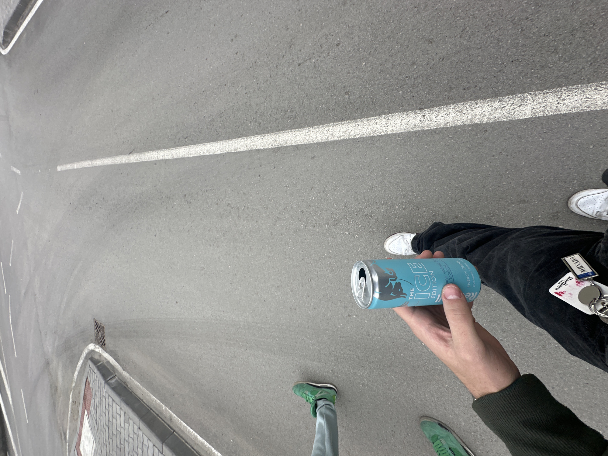Person drinks Red Bull on street in Dryanovo