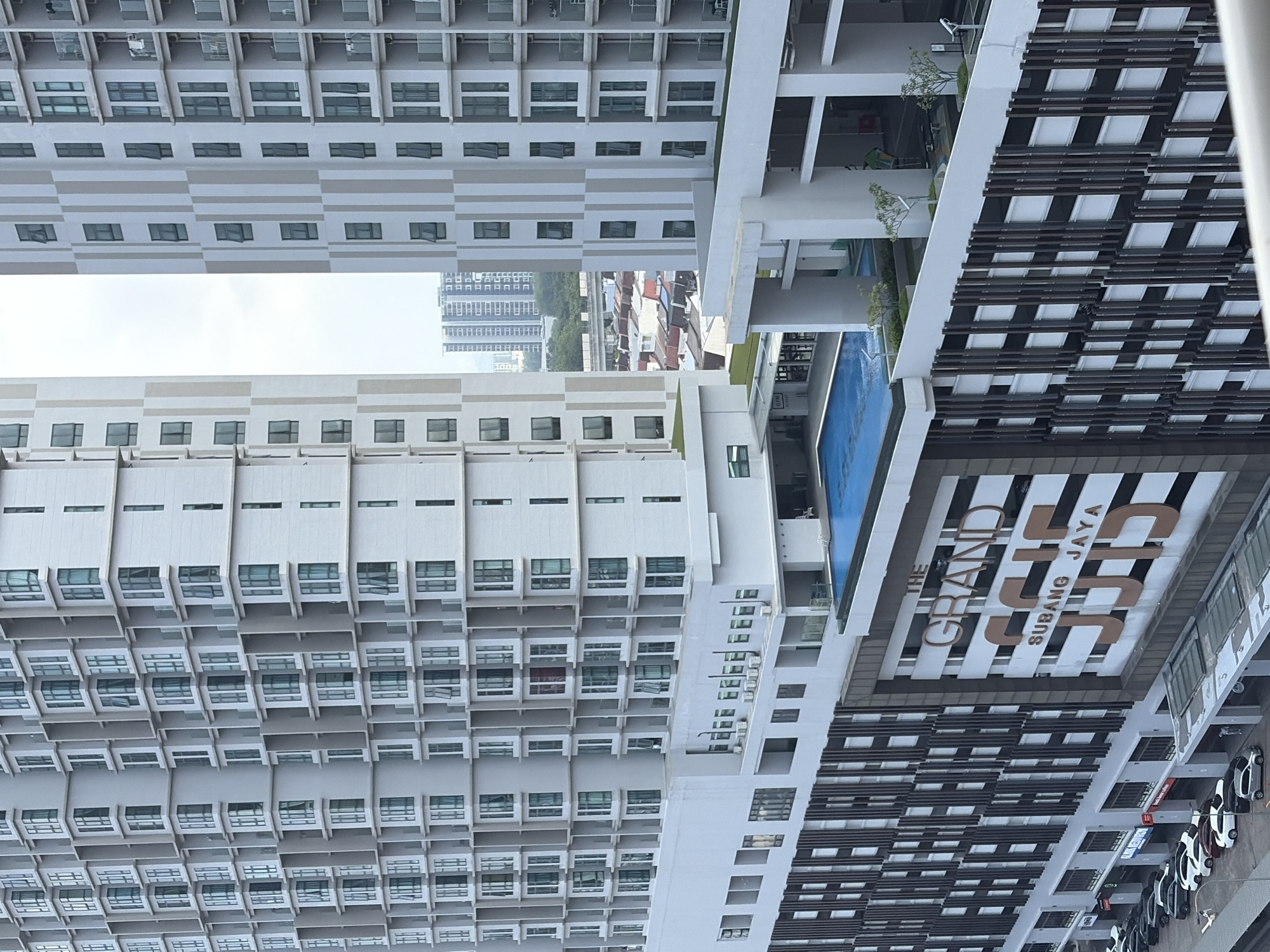 Twin residential towers rise over Subang Jaya's urban landscape.