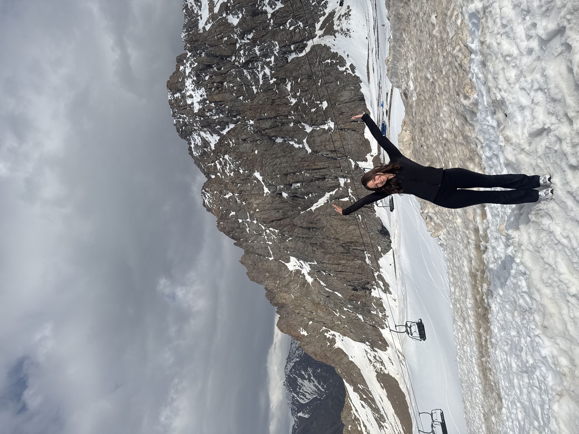 Woman poses on snowy slope at Almaty ski resort