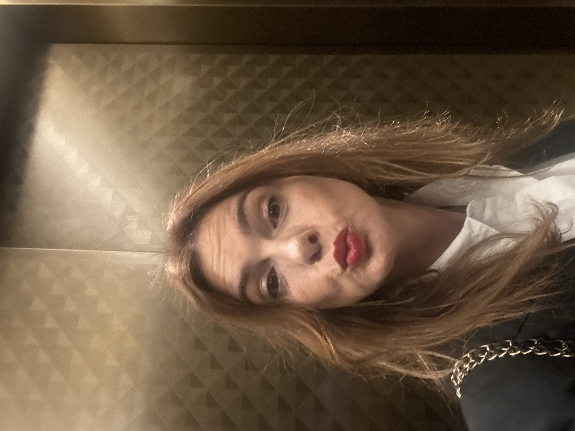 Woman takes multiple selfies on Munich's Maximilianstrasse