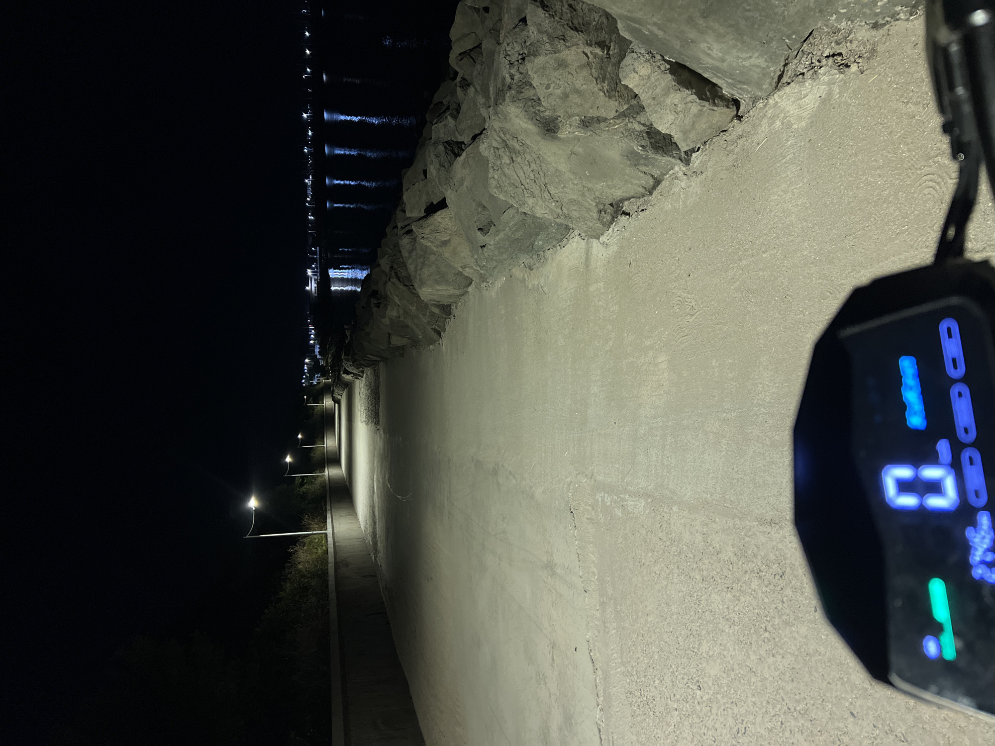 Parked e-scooter on Burgas waterfront breakwater at night