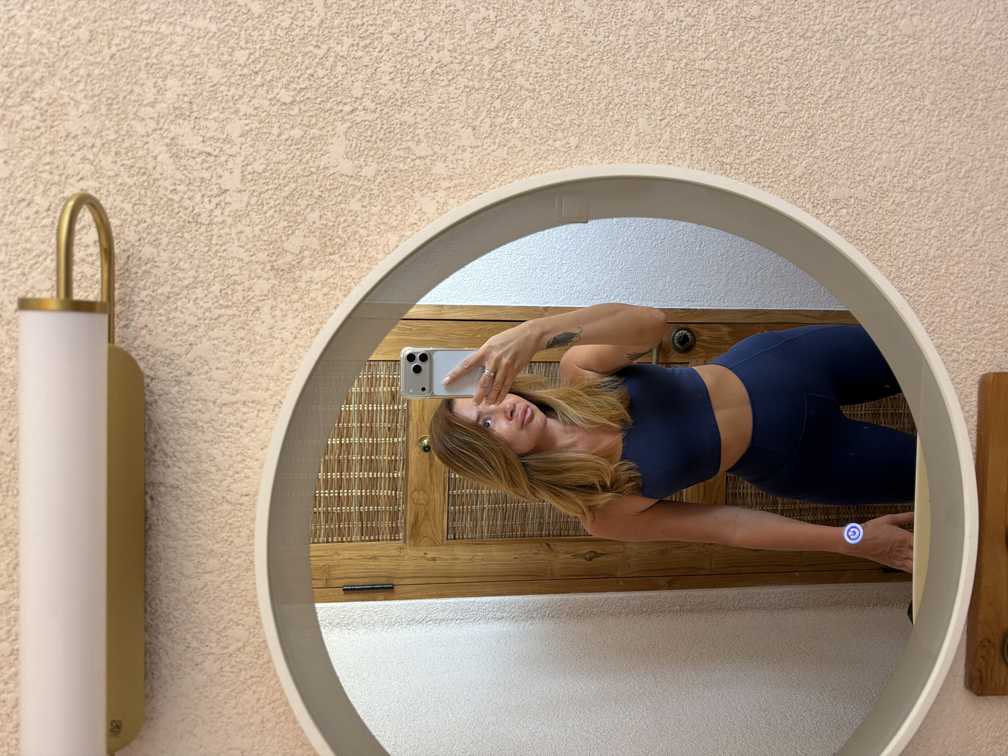Mirror selfies with hair tools in a Mengwi bathroom