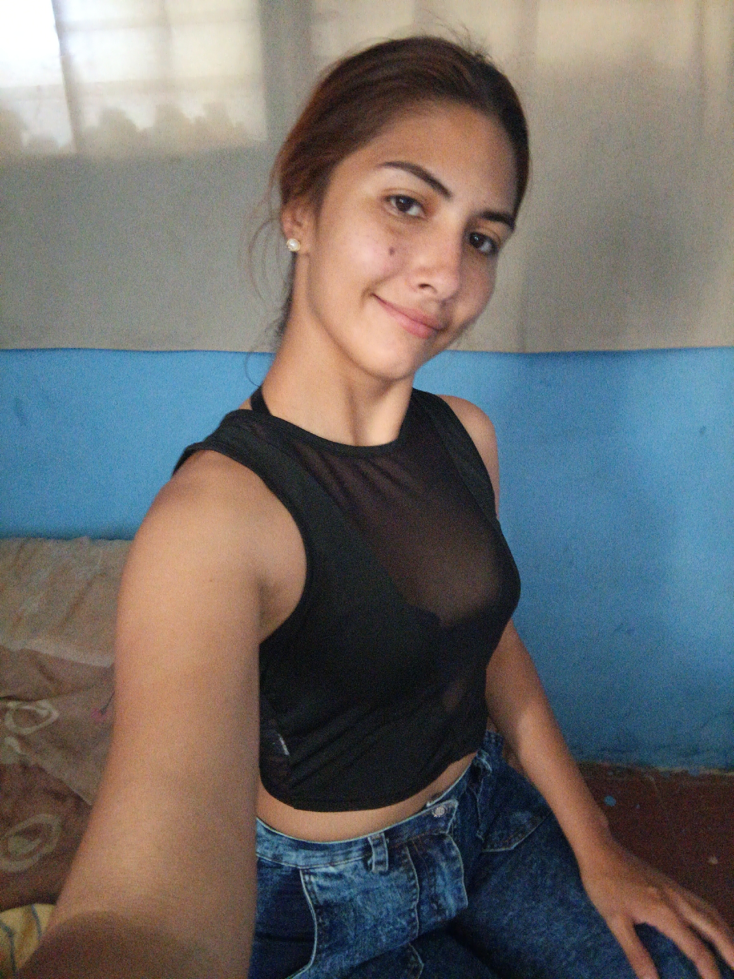 Casual selfie session in a Juan Griego bedroom, mid-afternoon