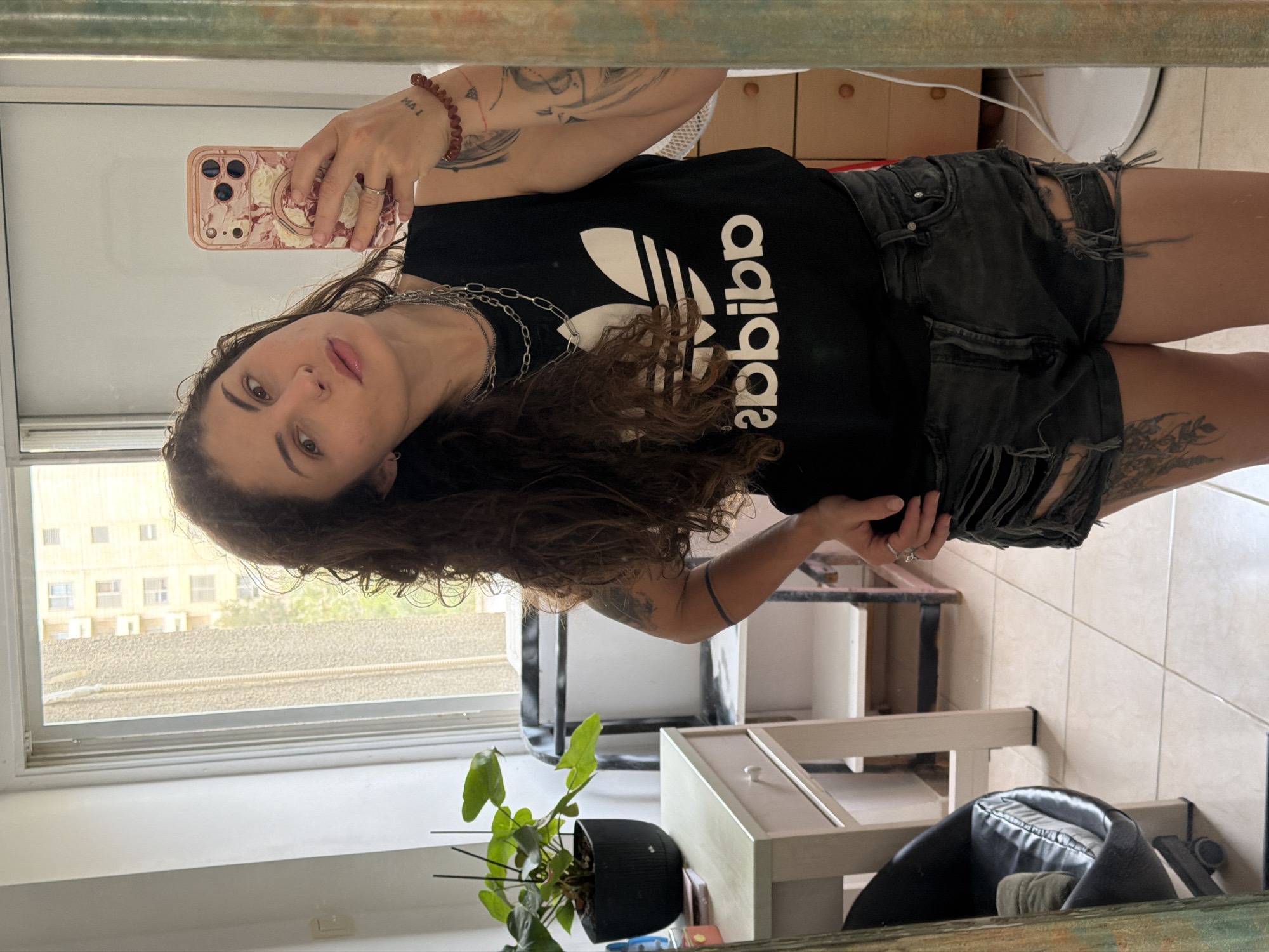 Woman takes morning selfies in Kiryat Bialik bathroom mirror