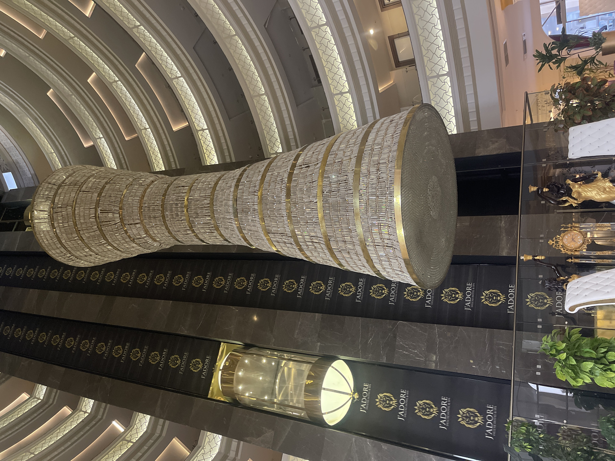 Hotel atrium's grand chandelier captured in upward architectural view