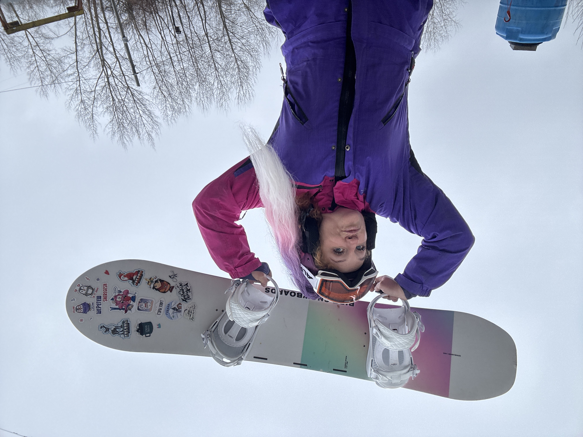 Snowboarder poses with gear in Chaikovsky, Russia