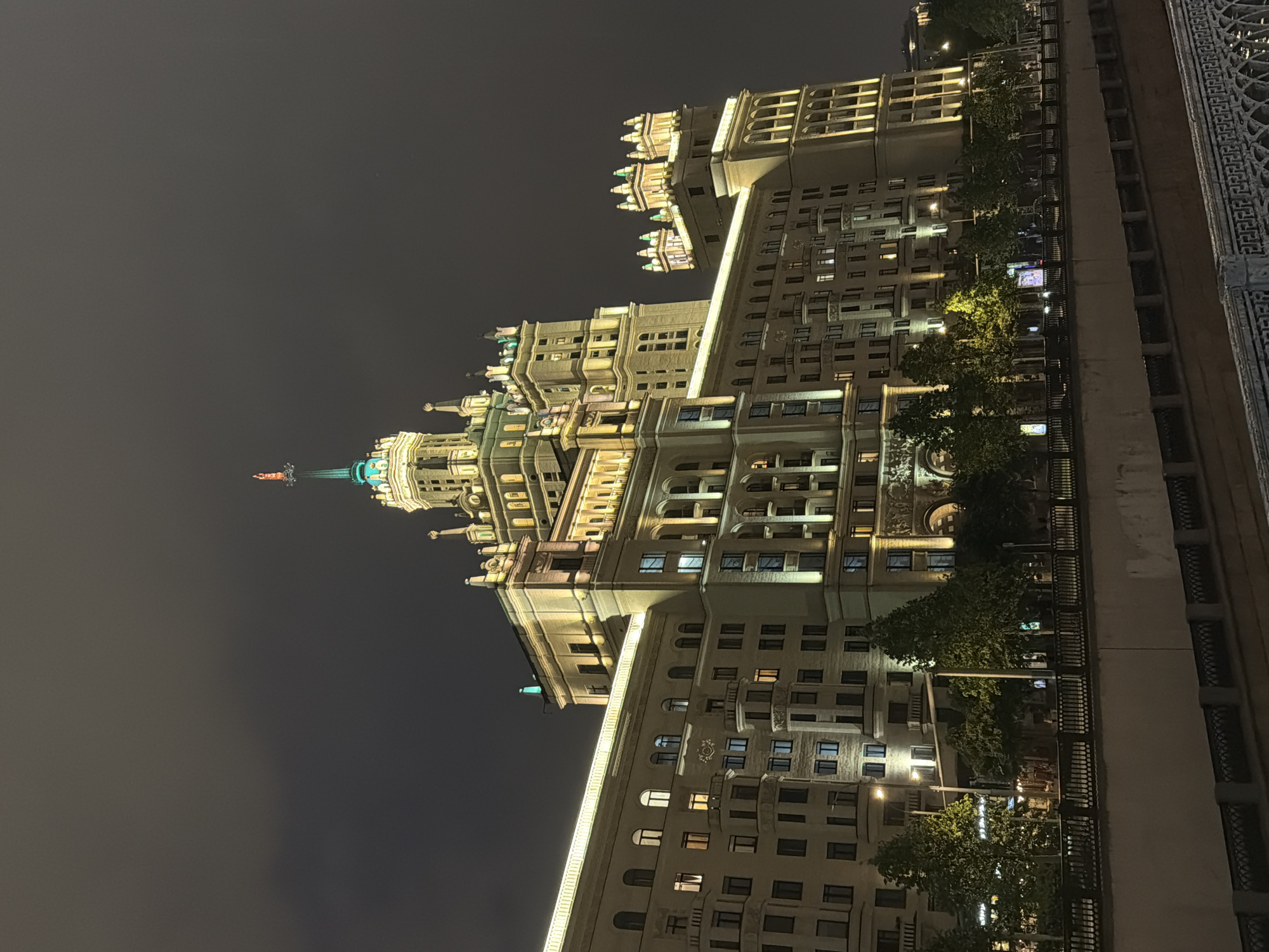 Illuminated Stalinist skyscraper observed at night in Ukraine