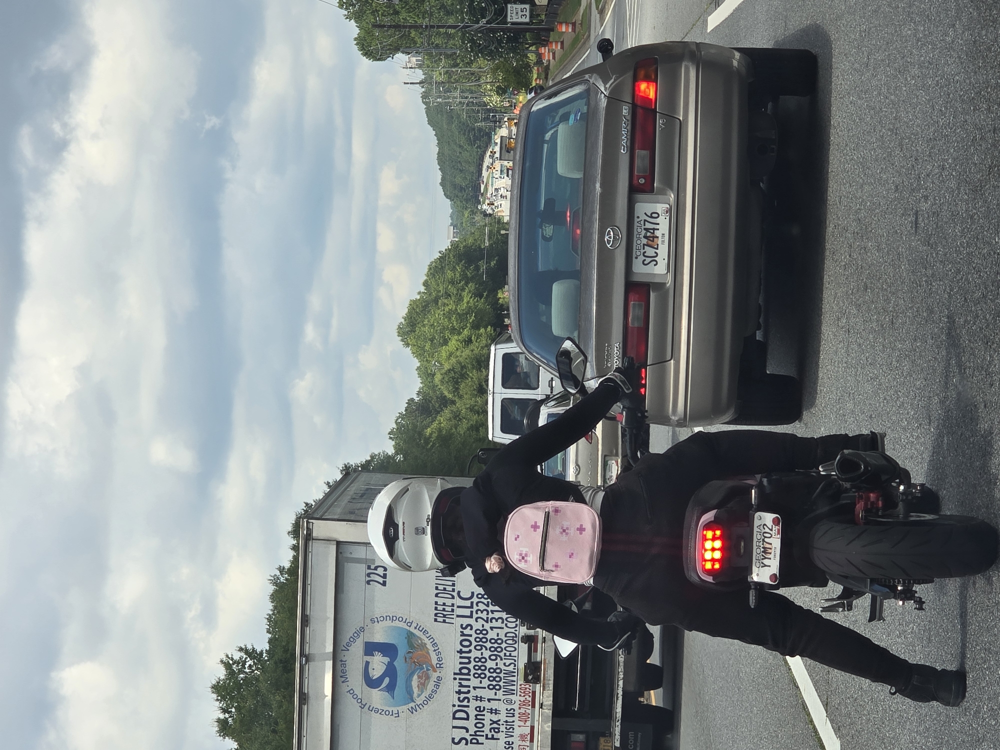 Two riders on a black motorcycle in Alpharetta, Georgia