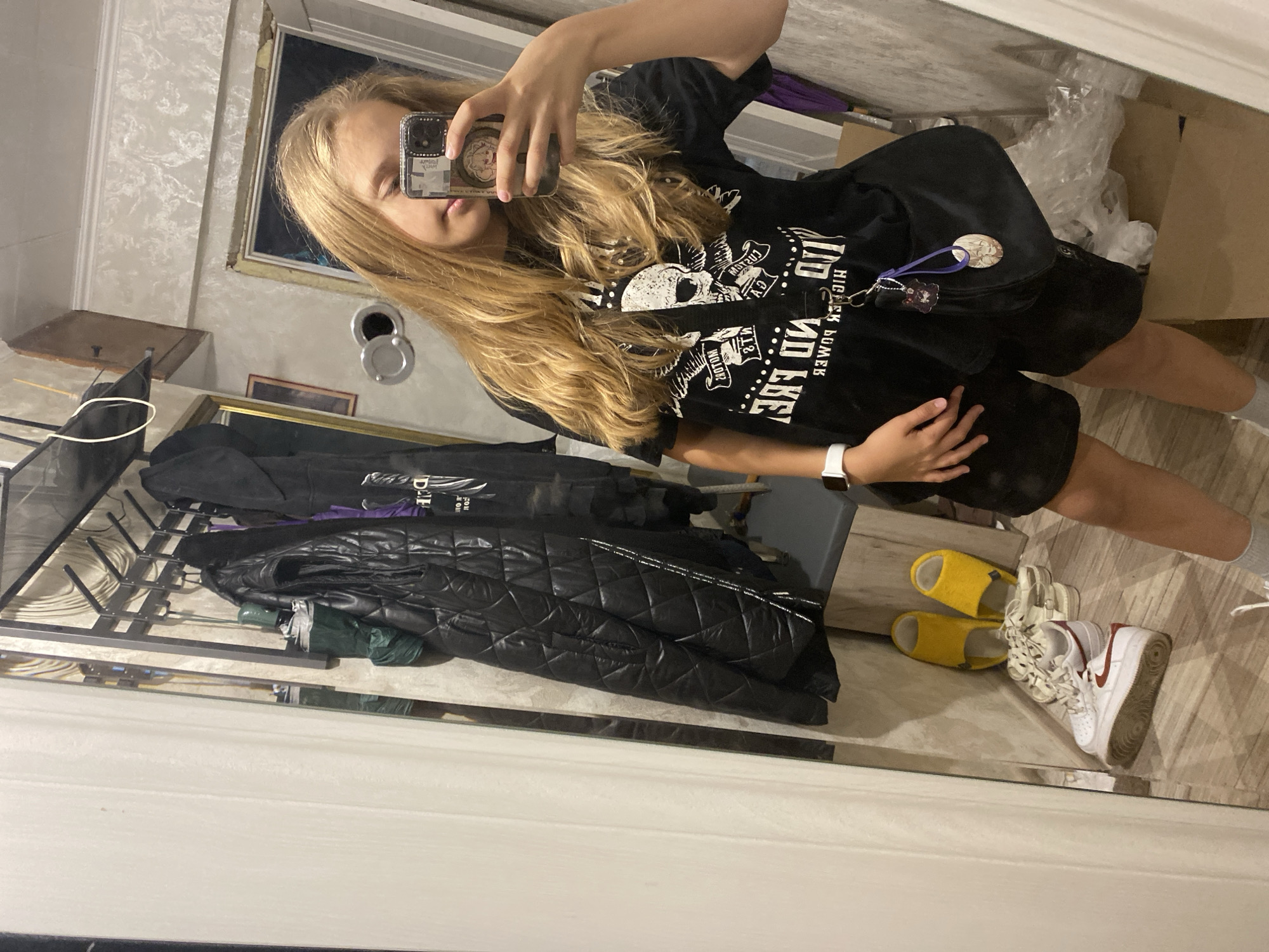 Mirror selfie in Sochi, skull graphic tee on display