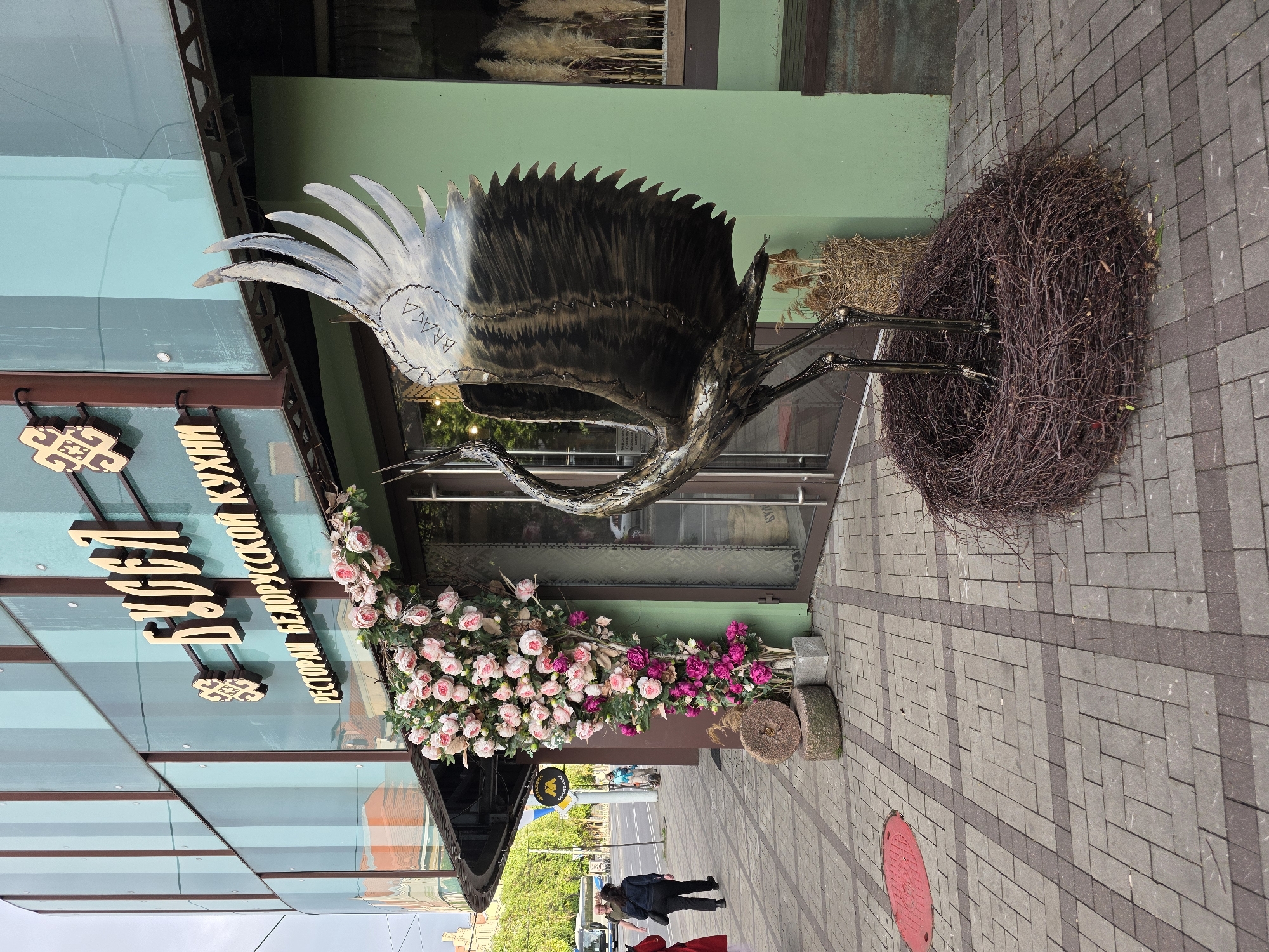 Metal crane sculpture observed outside Kaliningrad restaurant
