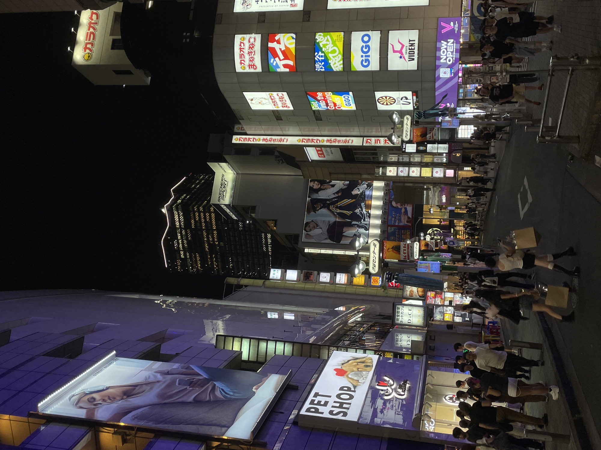 Shibuya at night: neon-lit streets and foot traffic