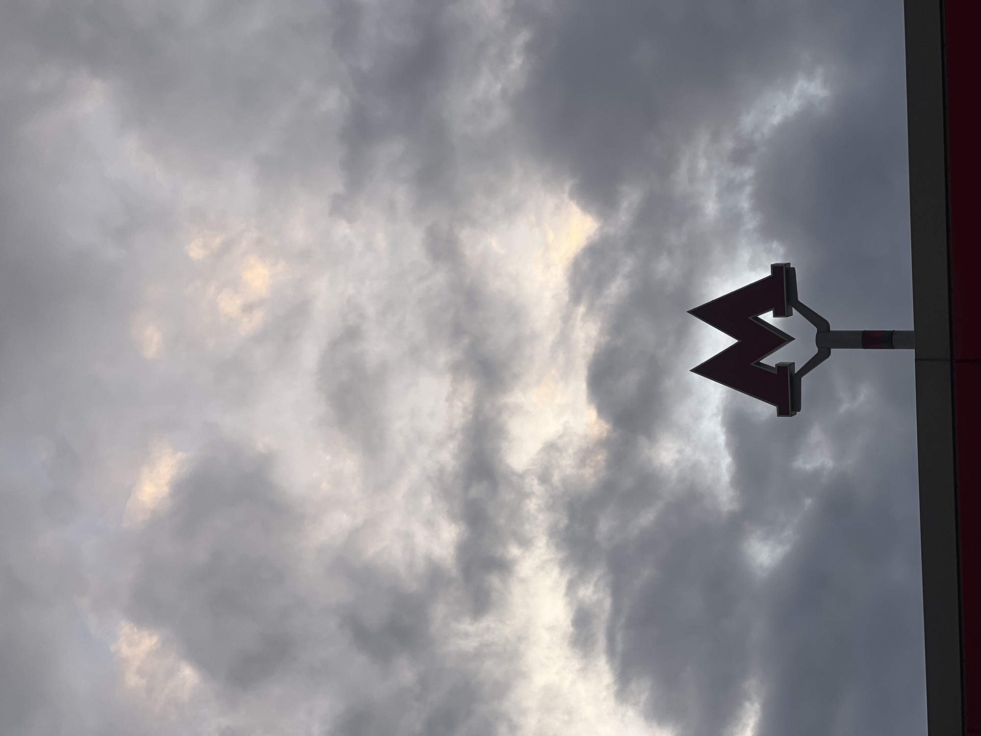 Moscow Metro sign photographed against cloudy sky in Kommunarka