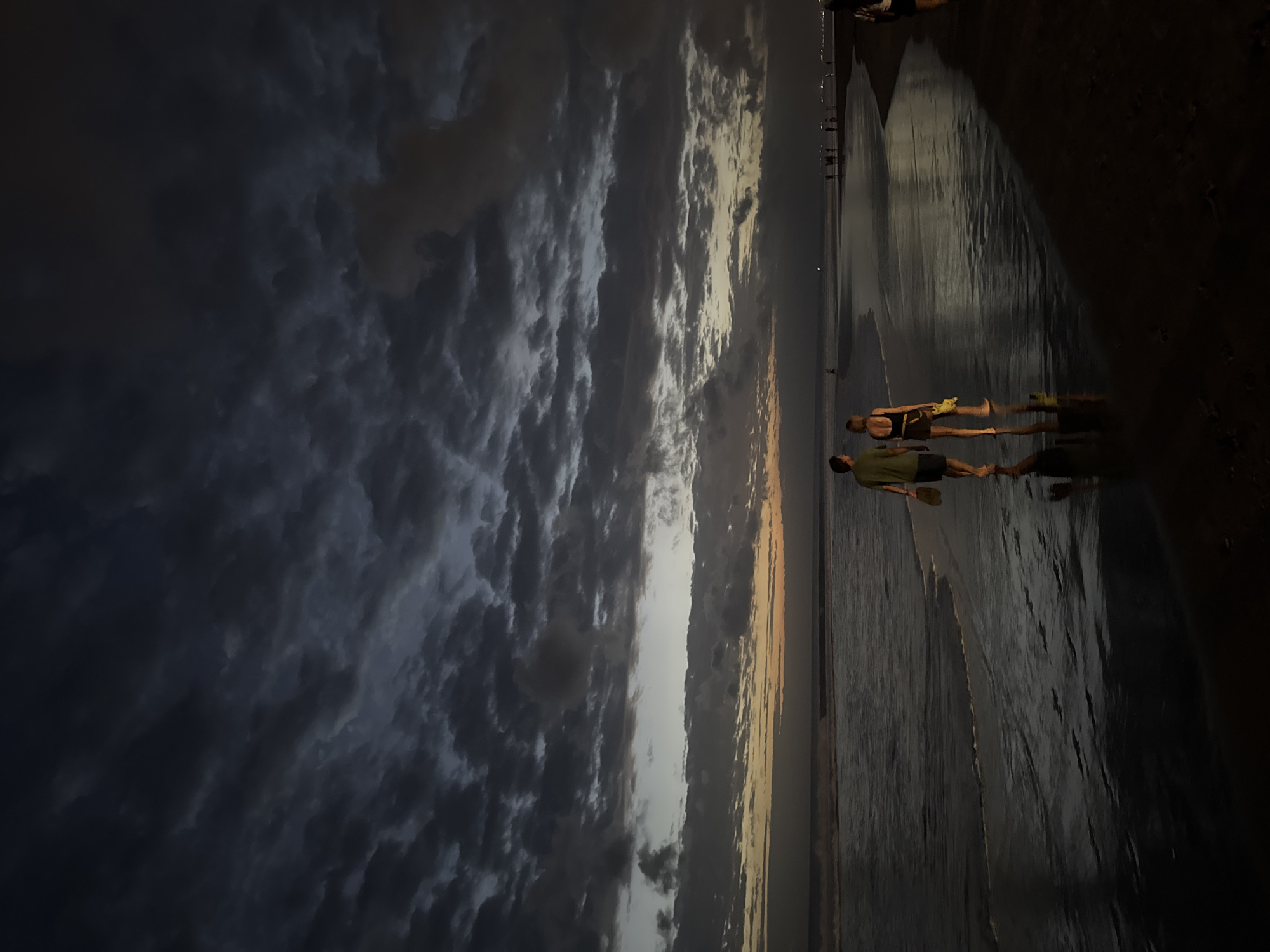 Evening beach life unfolds at Kuta during dramatic sunset