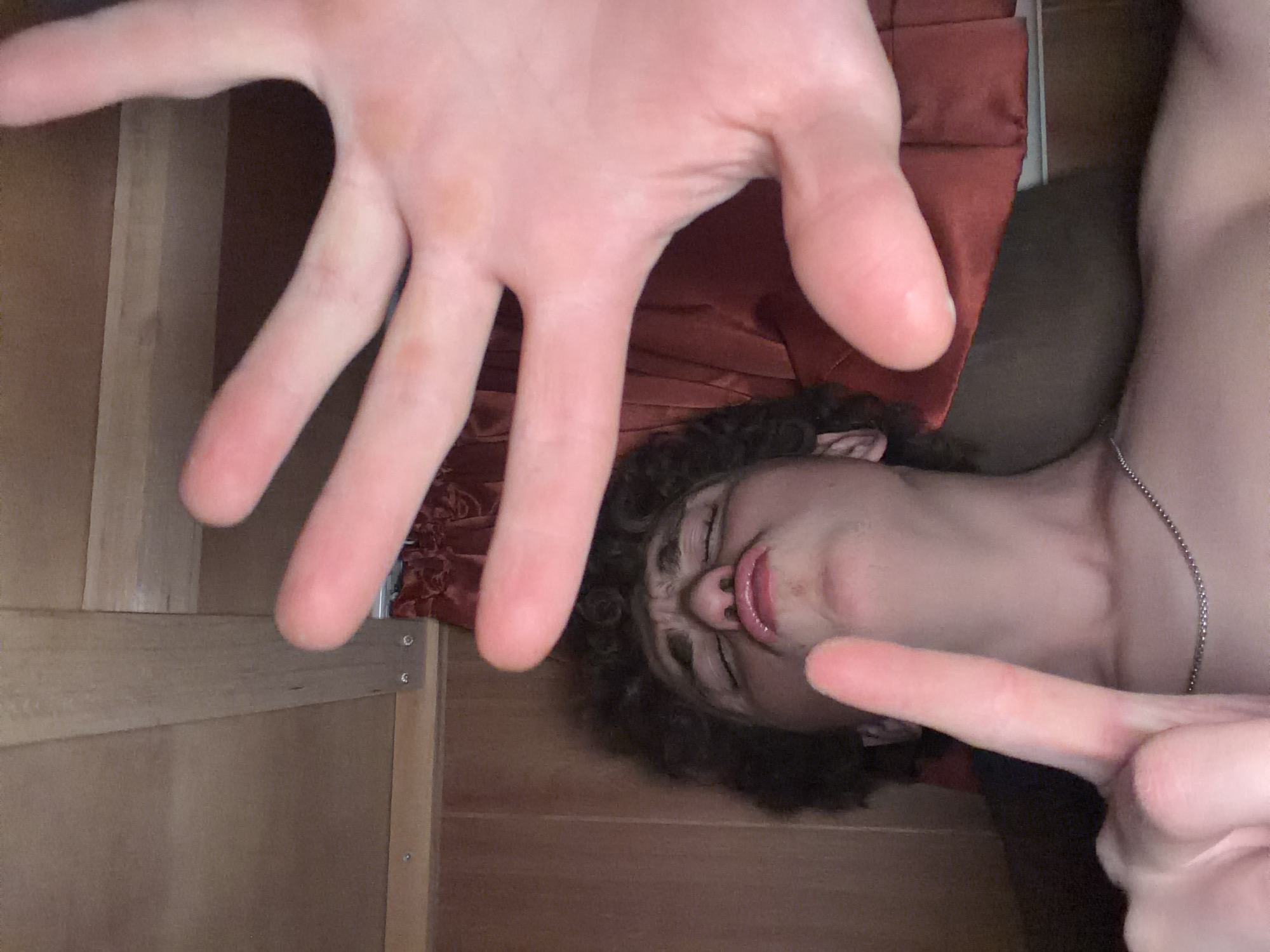 Goofing around with selfies lying down, all gestures and expressions.