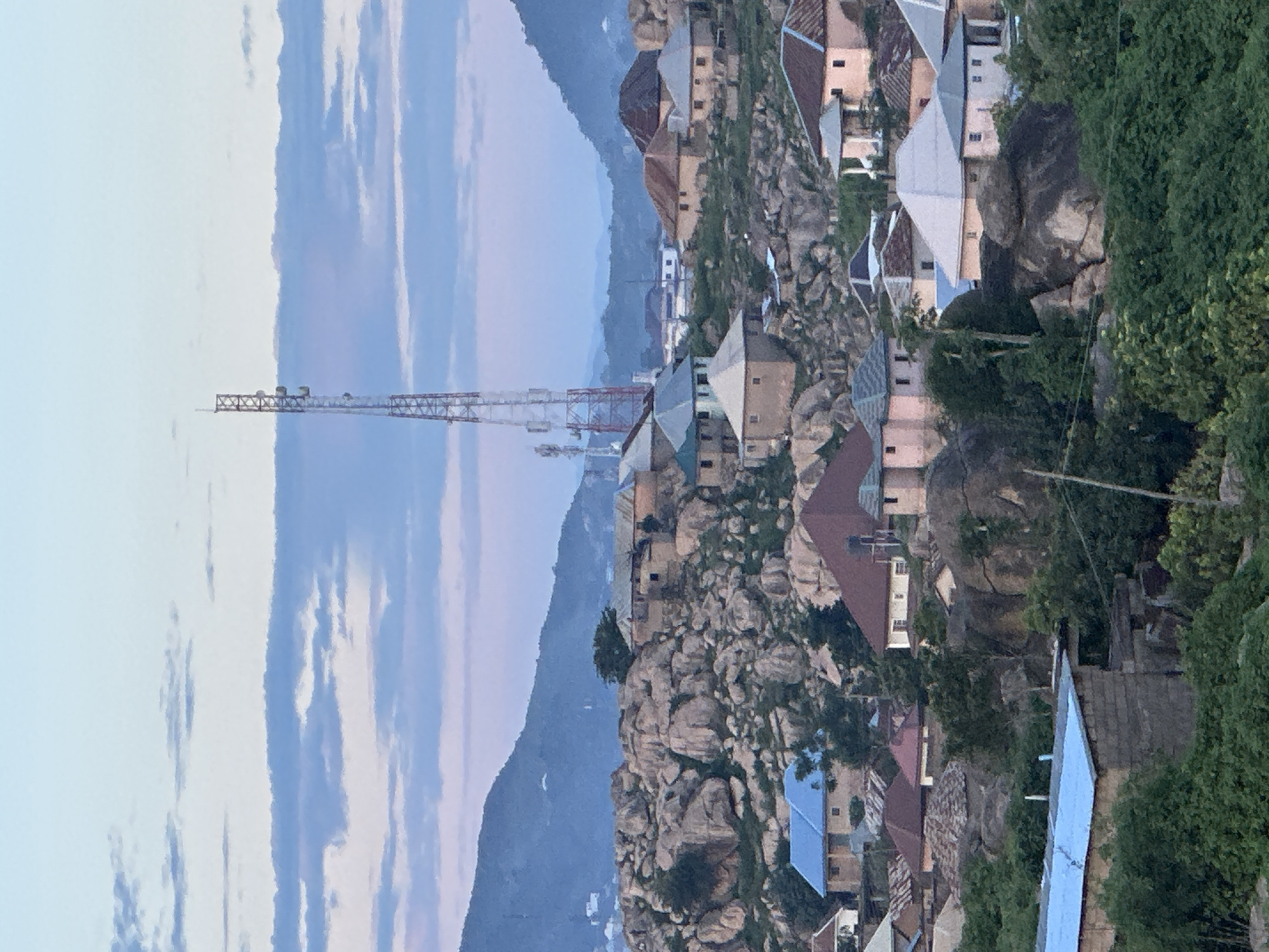 Jos, Nigeria: rocky hillside city at dusk, street level to aerial