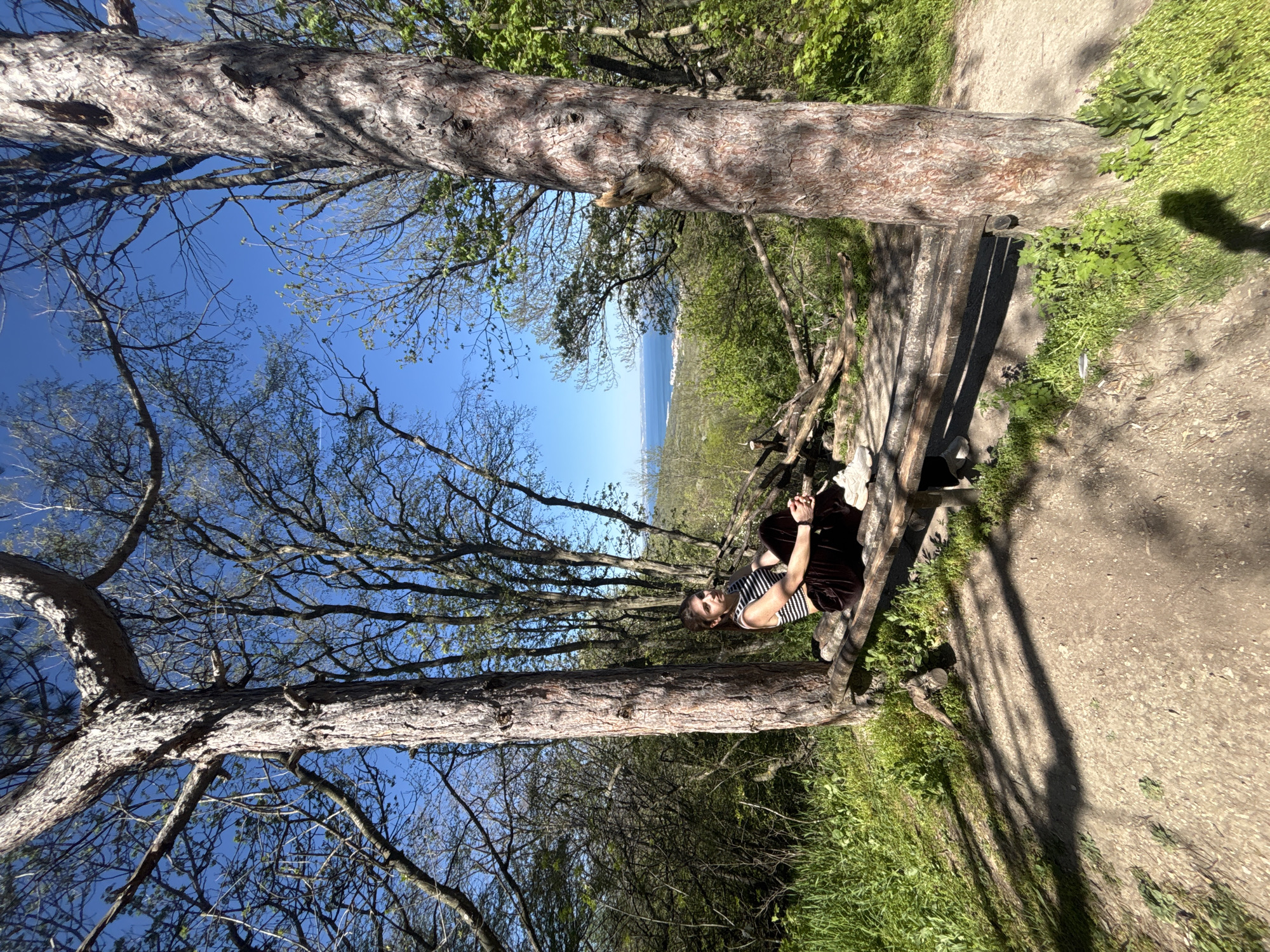 Woman enjoys rope swing, benches in coastal woods near Varna