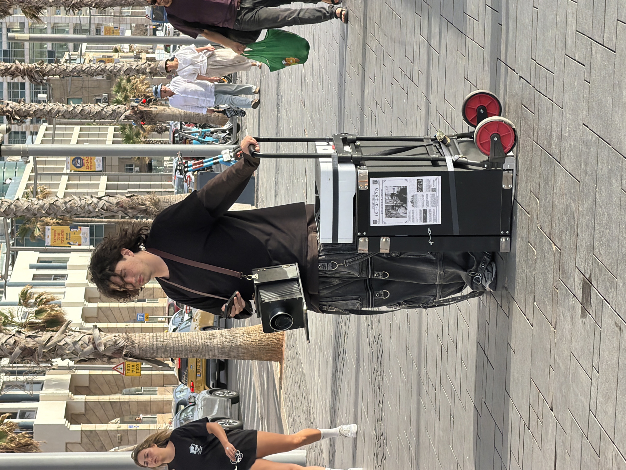 Photographer with suitcase spotted on Tel Aviv street