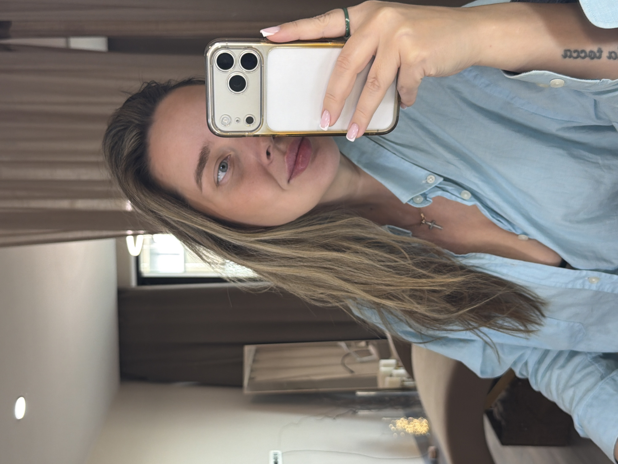 Woman takes selfie with gold phone in Moscow